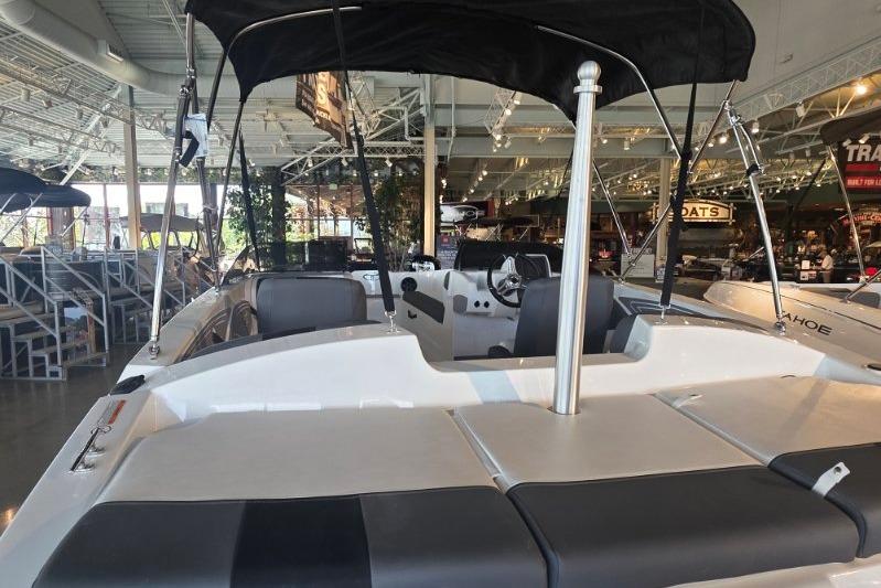 2026 Tahoe T21 boat displayed in a showroom with sleek seating and canopy.