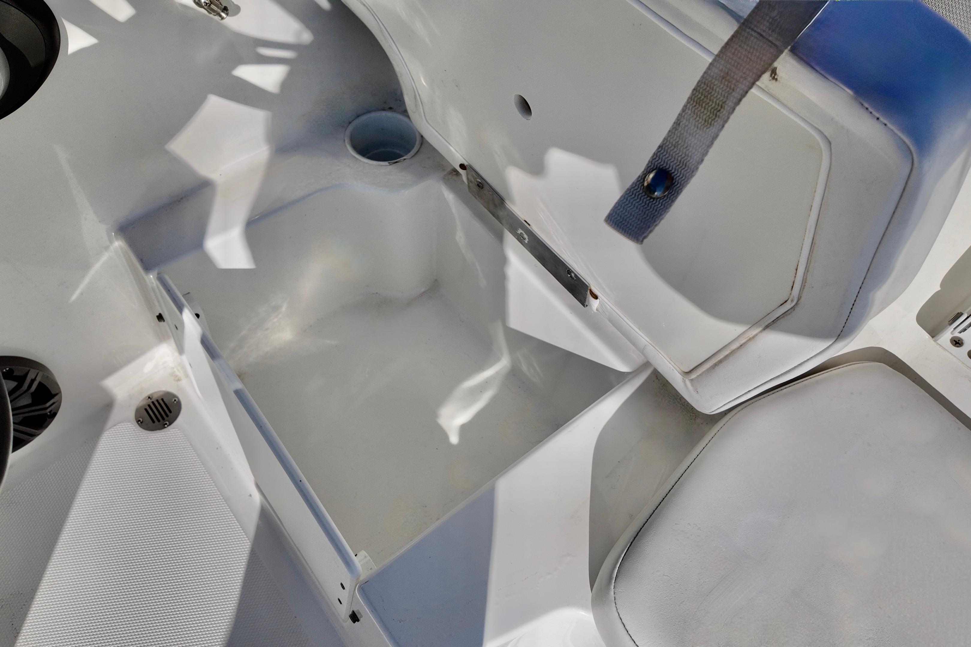 2024 Tahoe T18 boat interior storage compartment with open lid and seating area.
