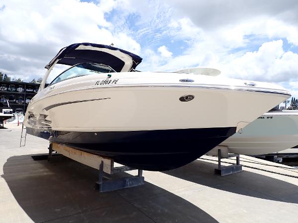 2011 Chaparral 287 SSX boat on display under a cloudy sky.