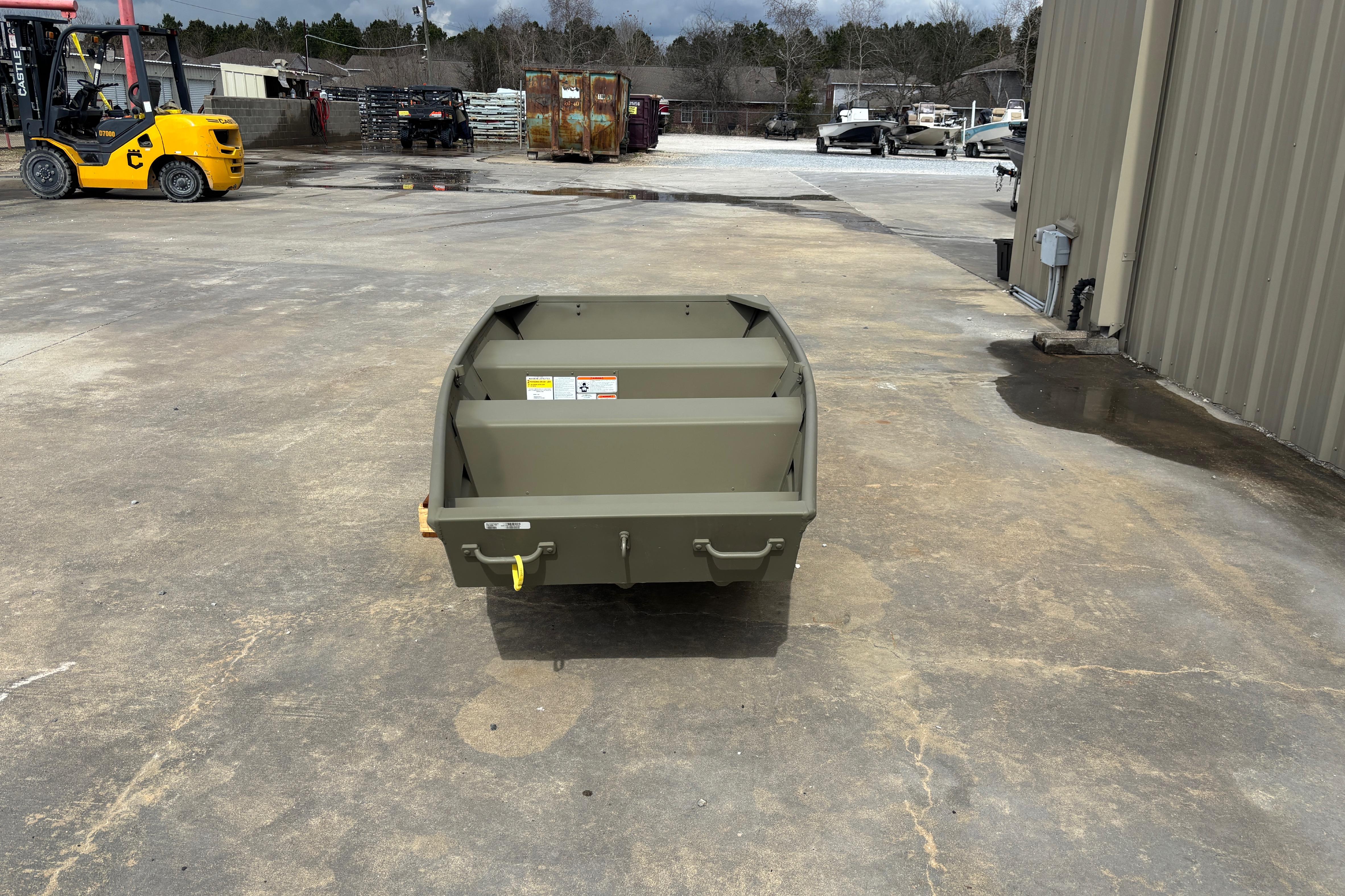 2026 Tracker Grizzly 10 Jon boat on concrete lot, with industrial background.