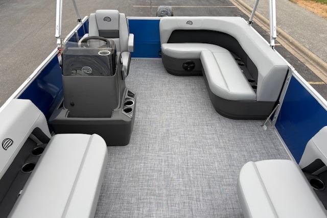 2026 Sun Tracker Party Barge 16 DLX interior with gray seating and modern helm.