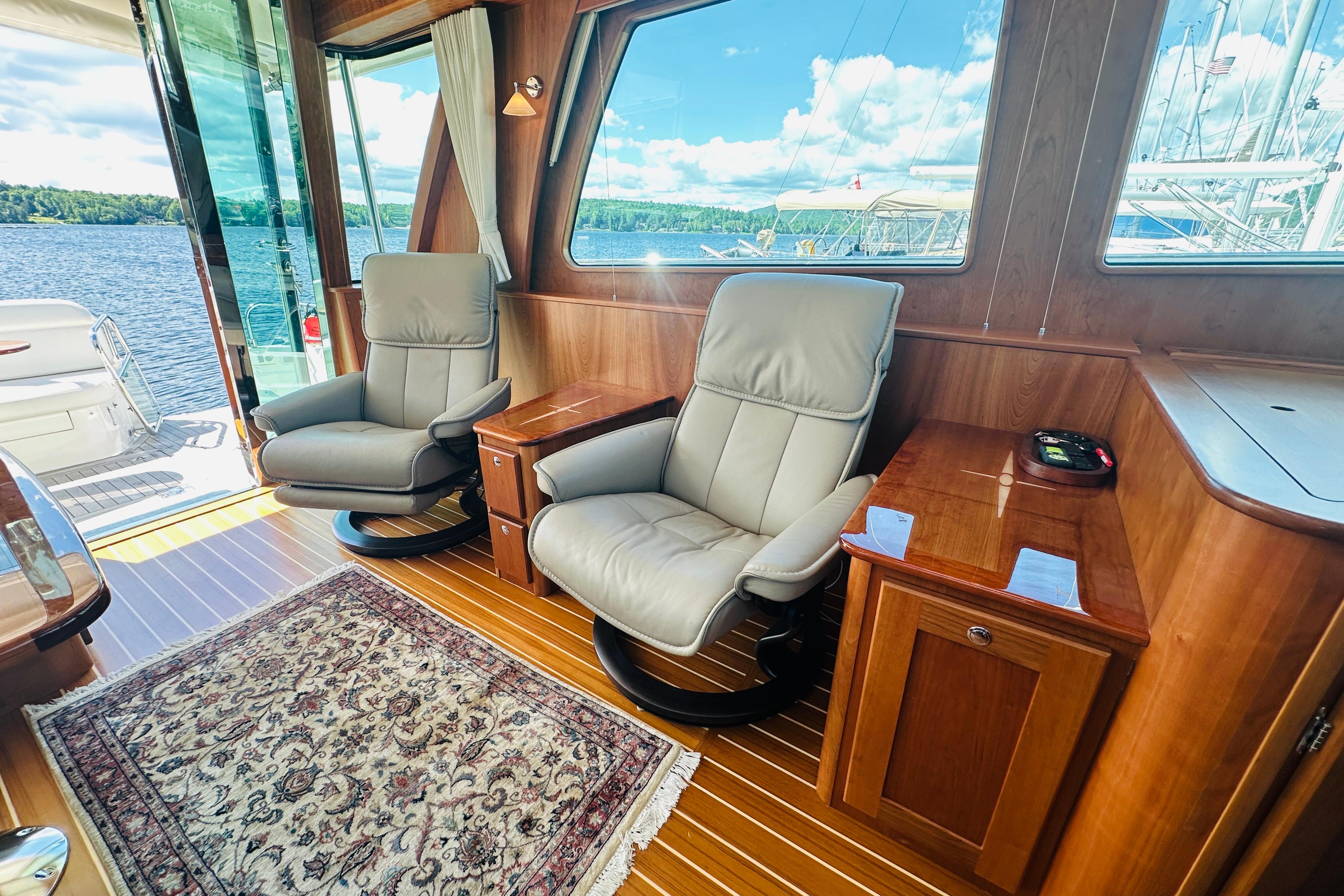 Luxurious interior of 2025 Sabre 48 Salon Express yacht with leather chairs and scenic view.