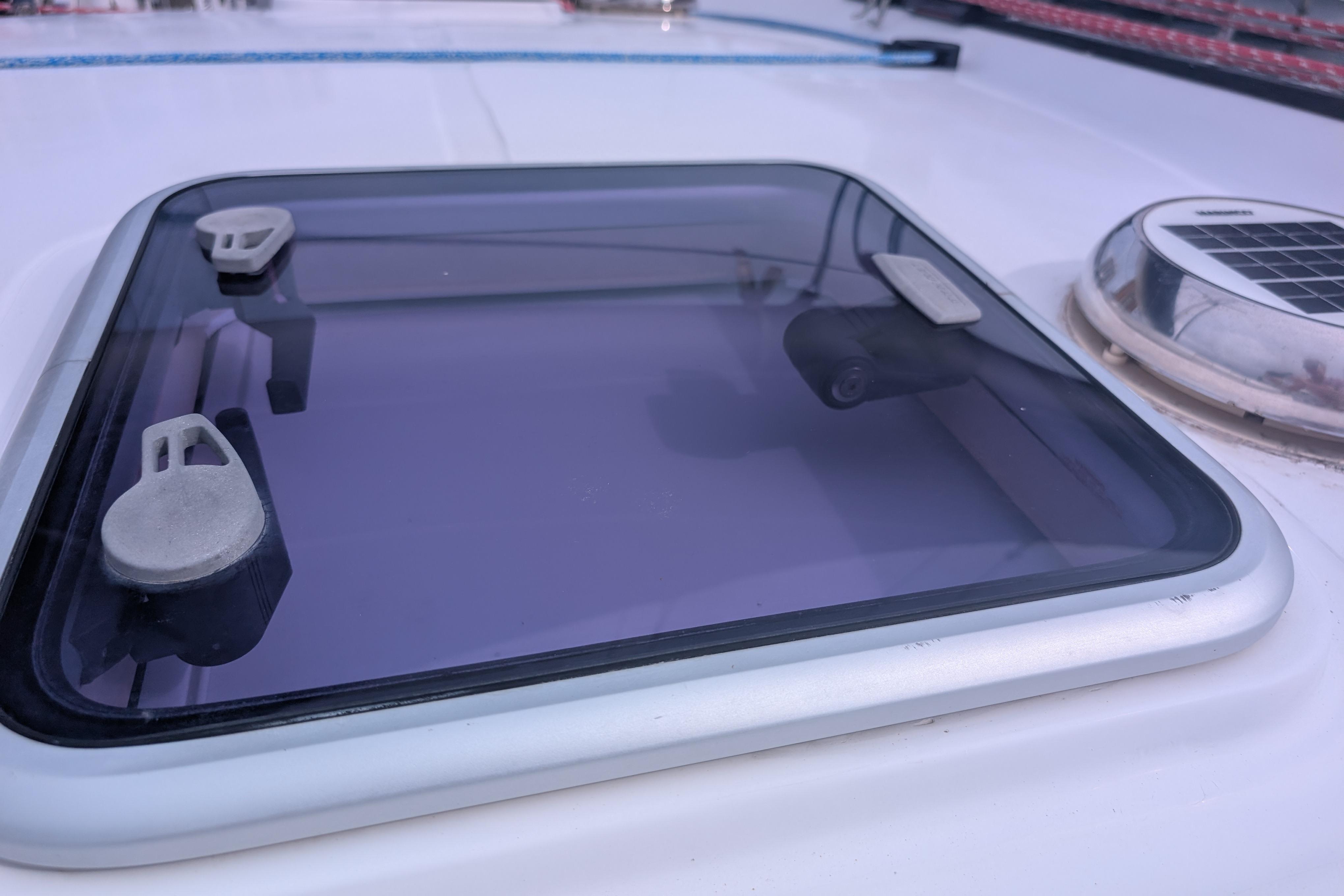 Hatch on 1999 Island Spirit 37 yacht deck with solar vent.