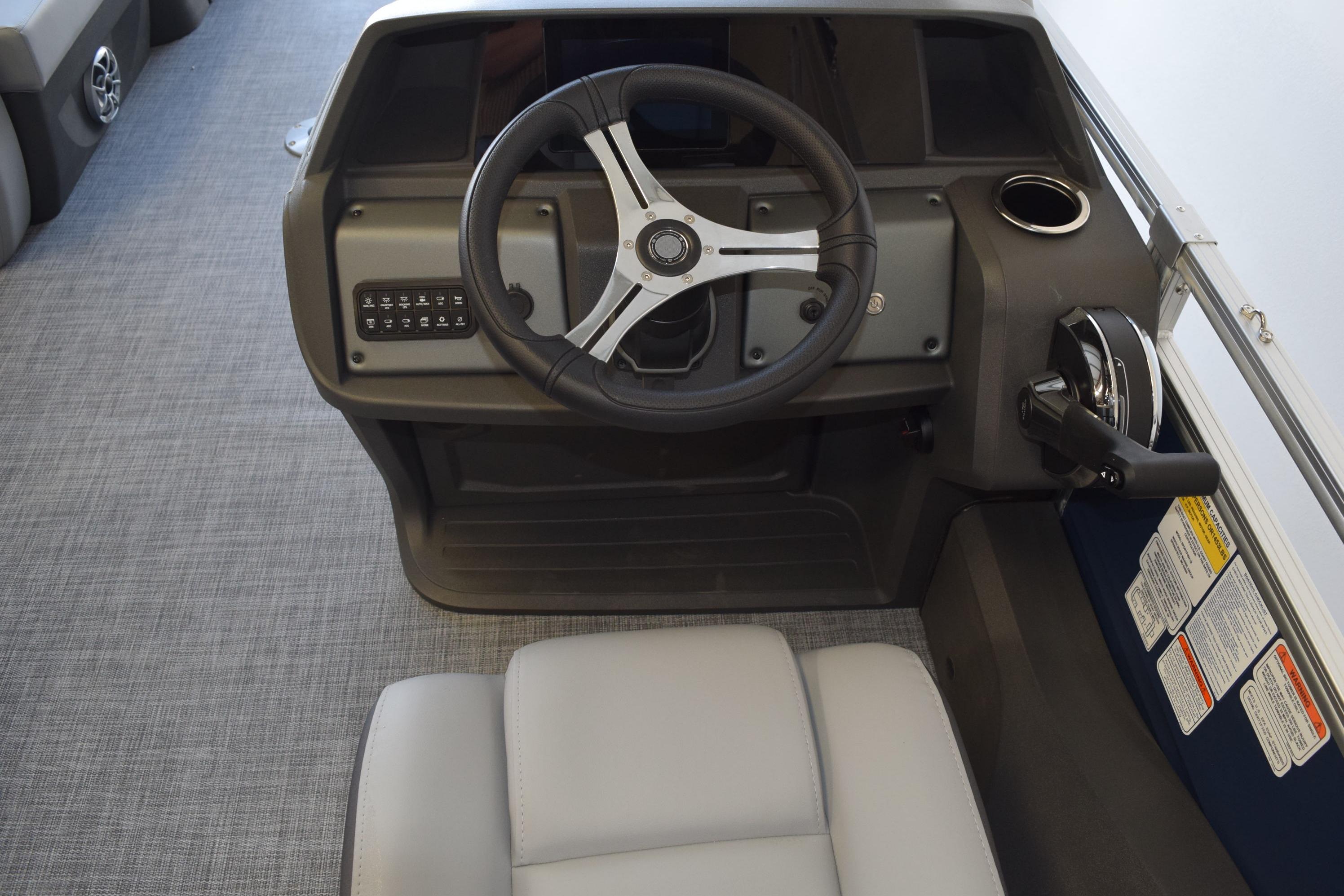 2026 Sun Tracker SportFish 22 DLX boat helm with steering wheel and controls.