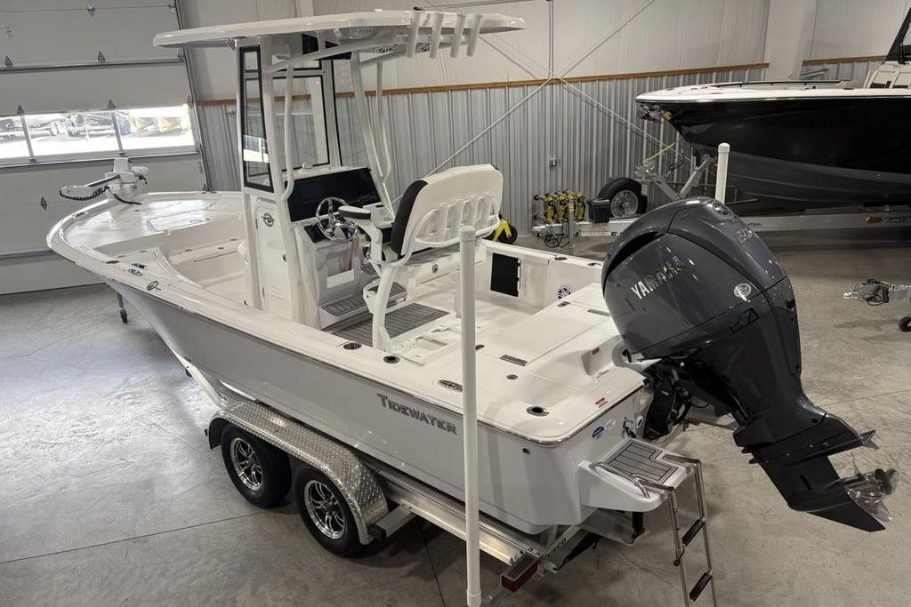 2026 Tidewater 2210 Carolina Bay boat in showroom, featuring Yamaha outboard motor.