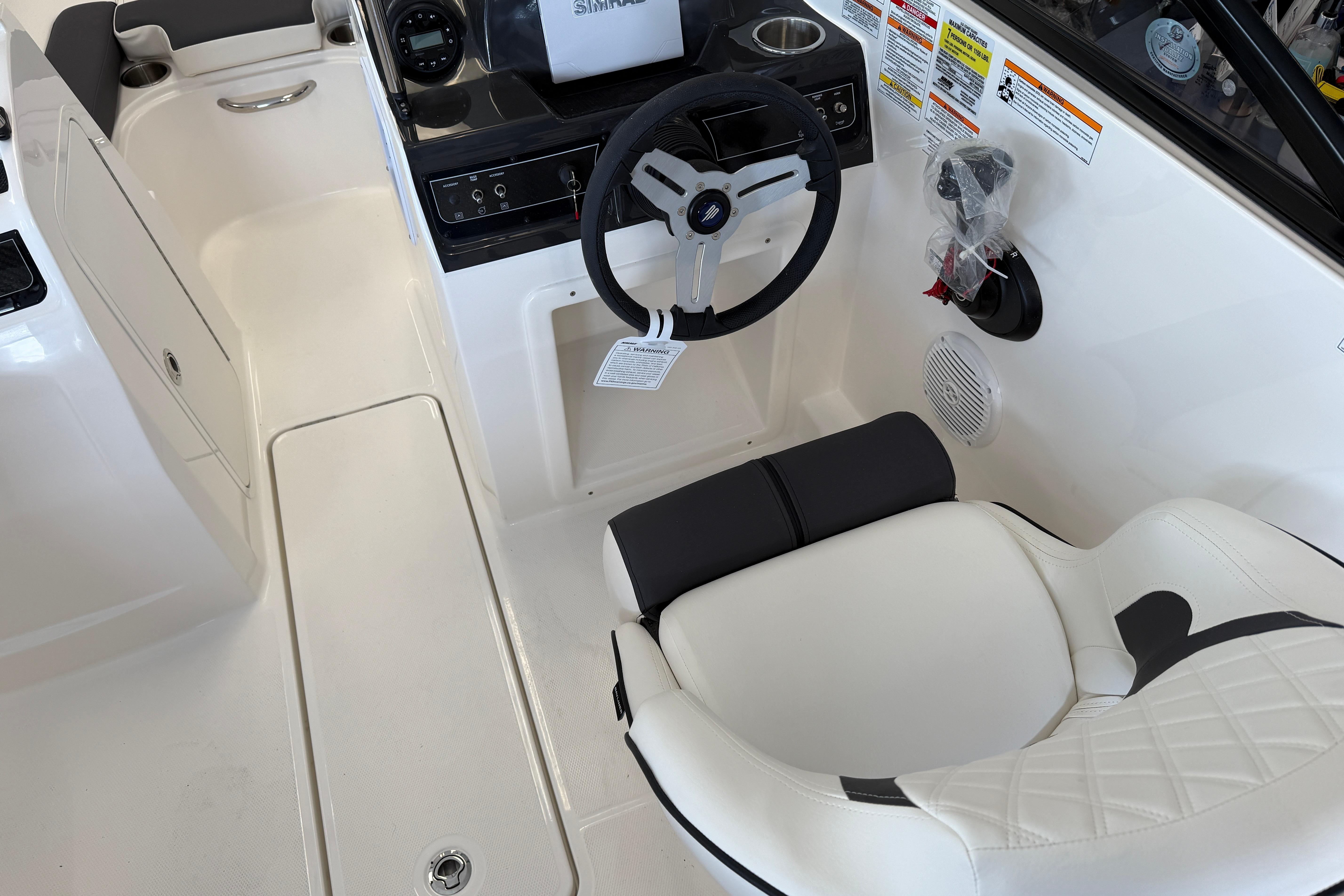 2025 Bayliner VR4 Bowrider OB interior with steering wheel and seating.