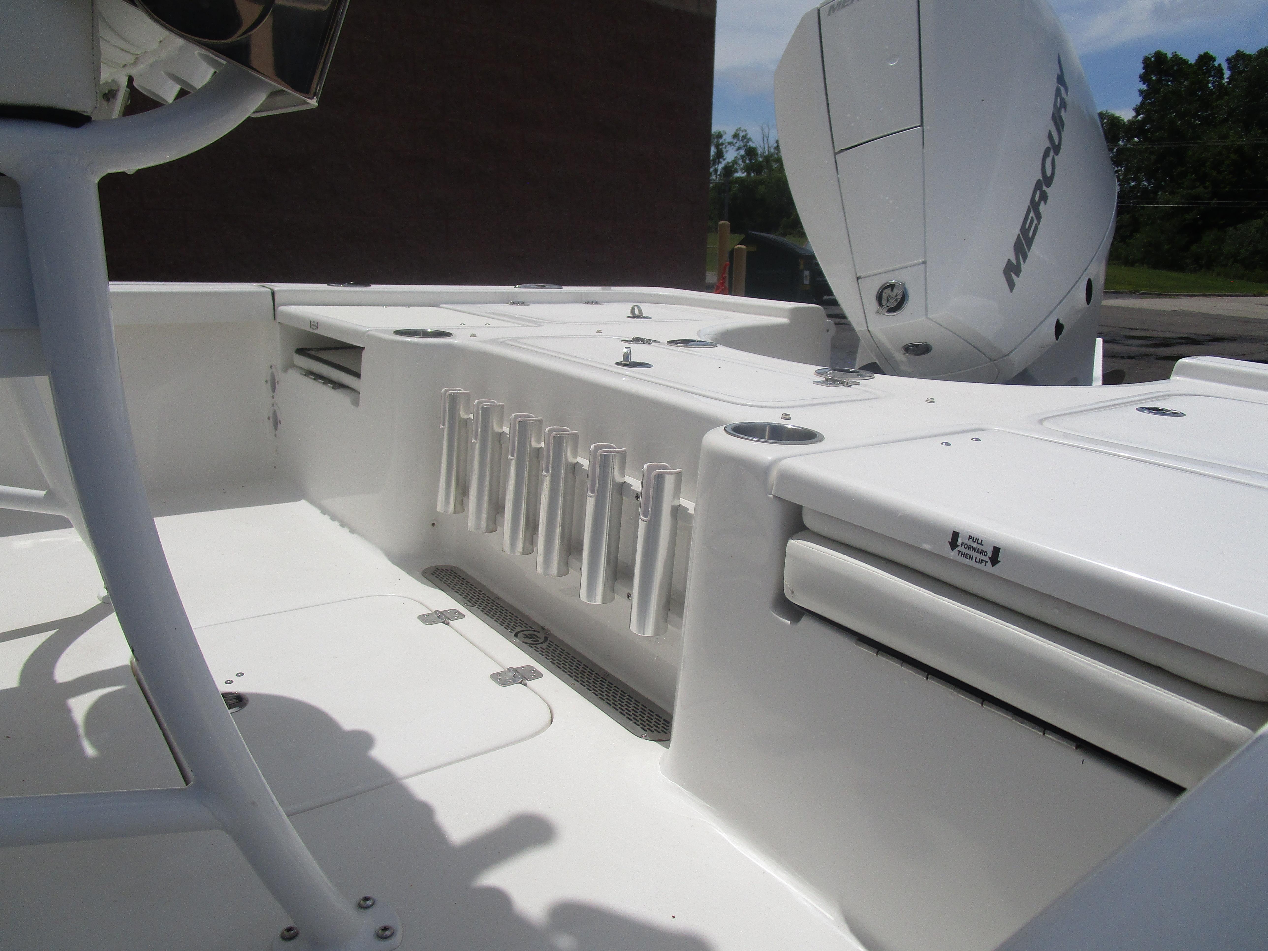 2025 Sea Pro 230 DLX BAY boat interior with rod holders and Mercury engine.