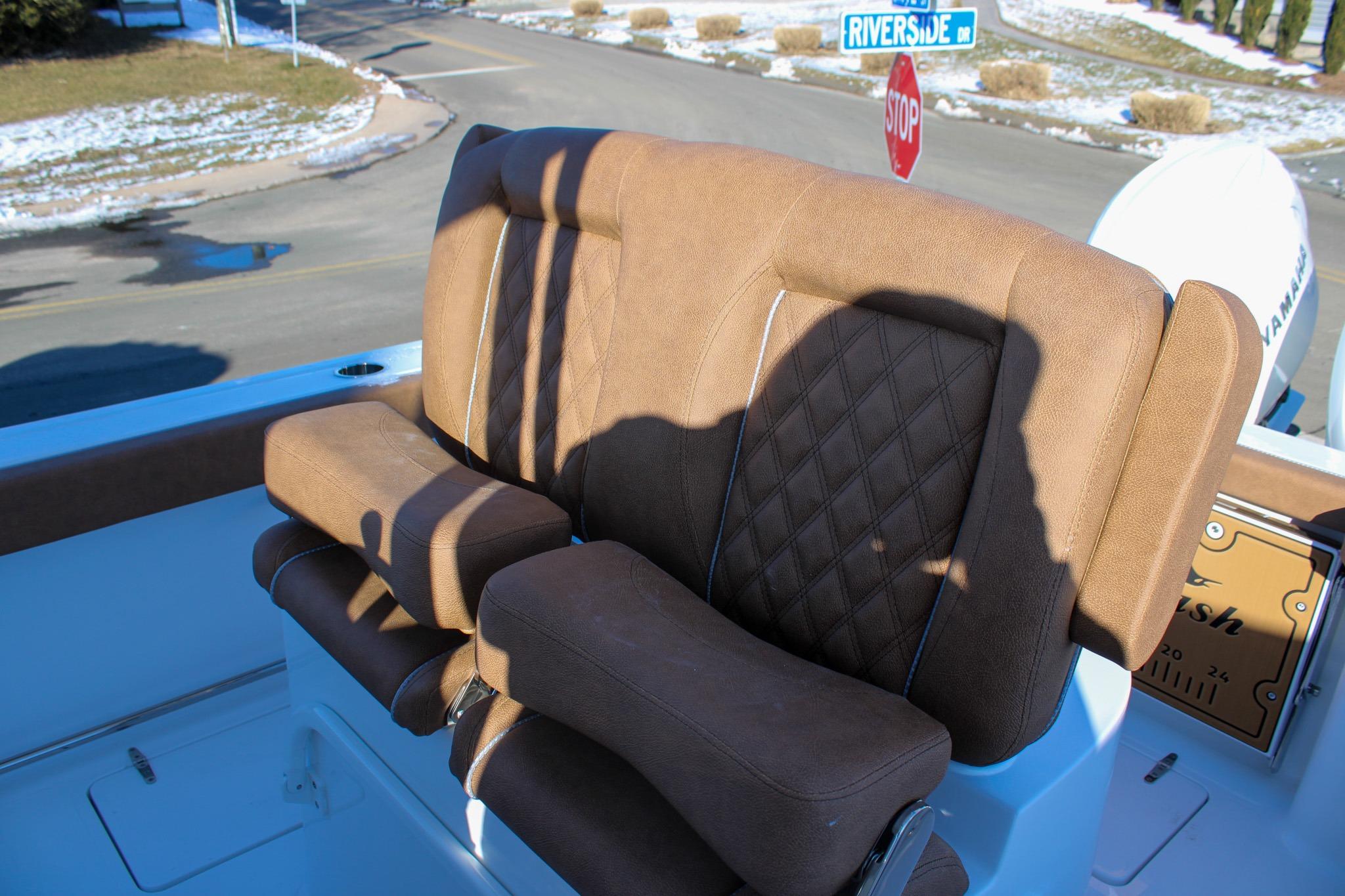 2026 Sea Hunt Gamefish 25 boat seat with brown upholstery and diamond stitching.