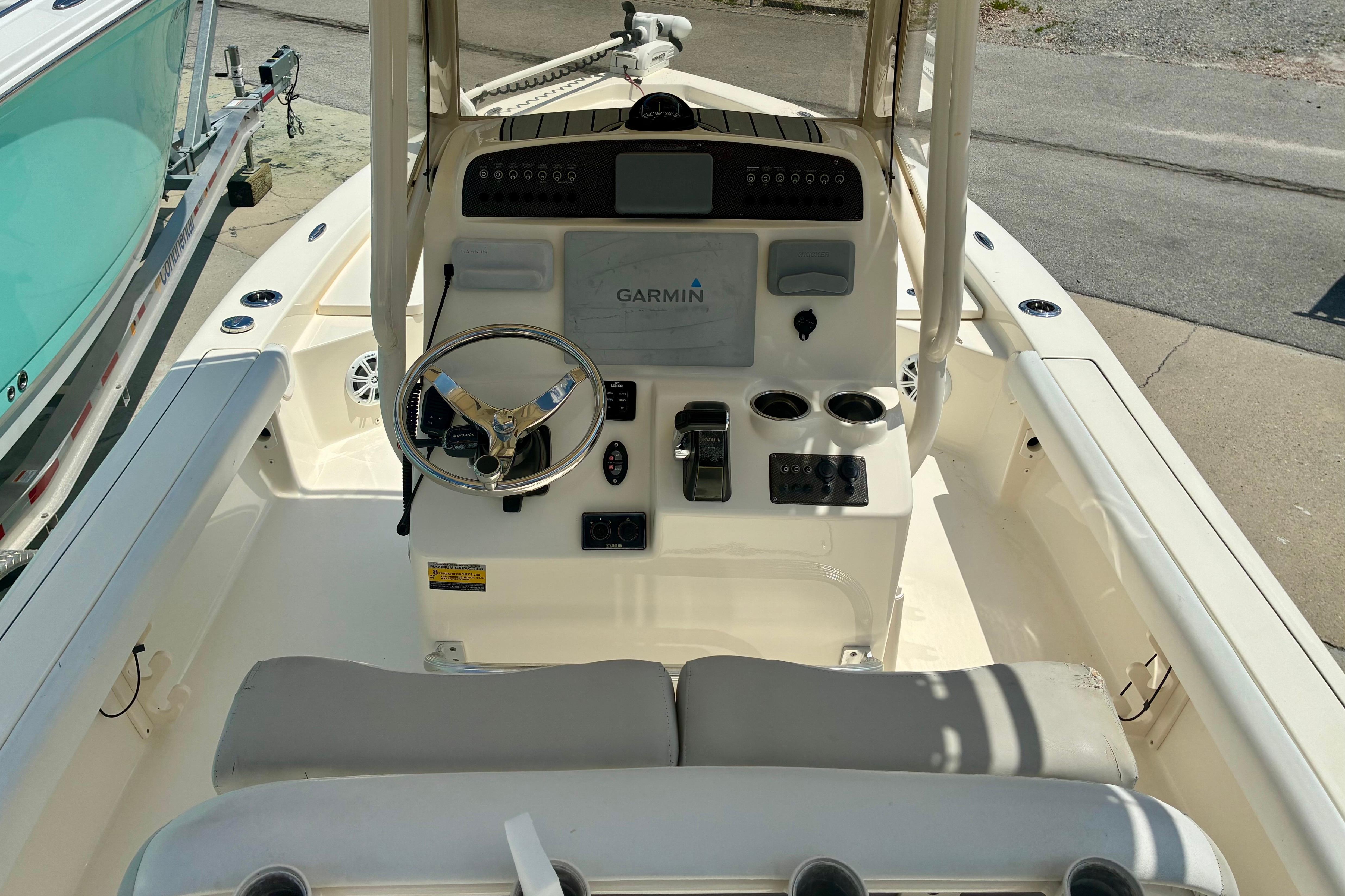 2018 Avenger AV24 boat cockpit with Garmin navigation system and steering wheel.