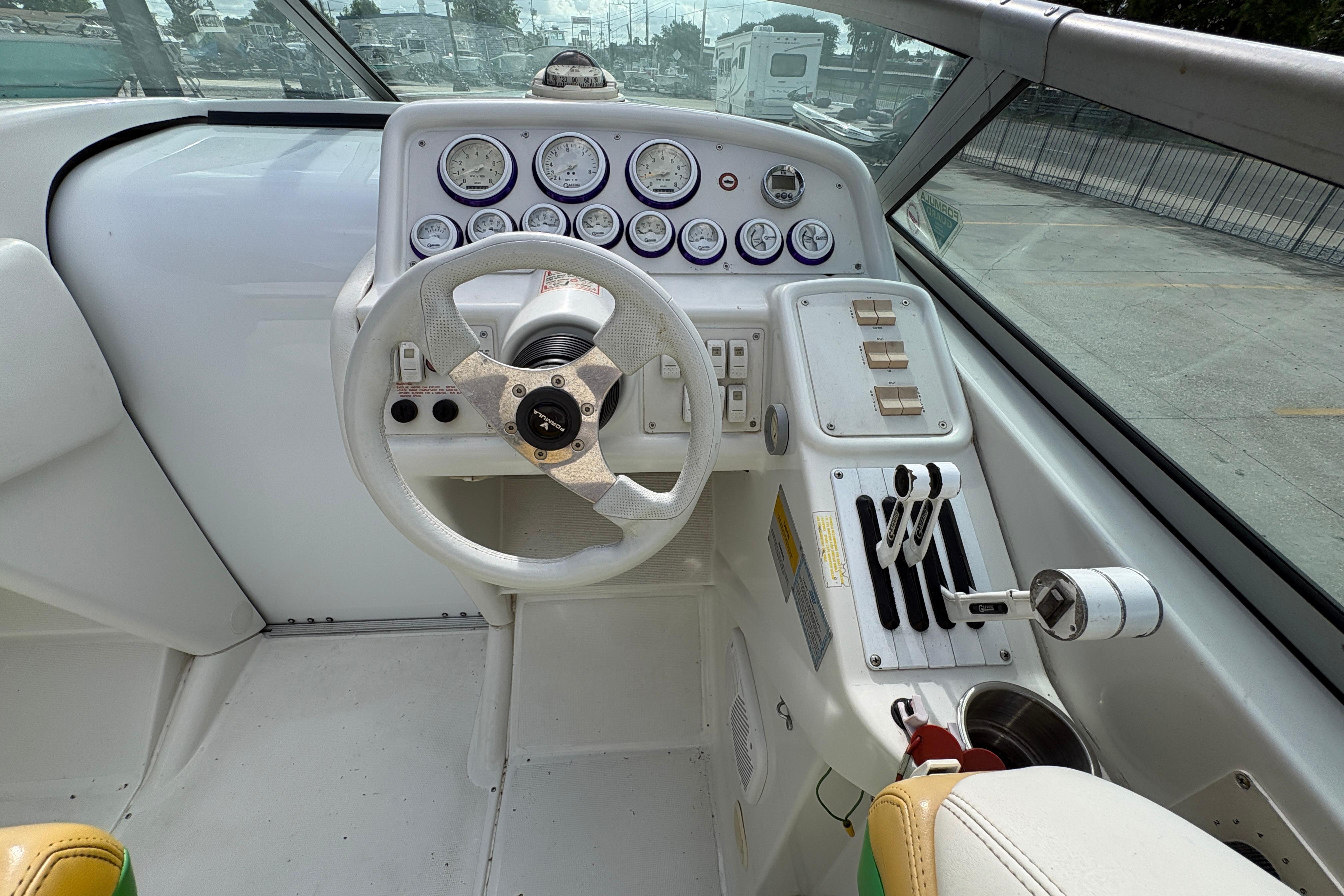 2002 Formula 292 FASTech boat cockpit with steering wheel and control panel.