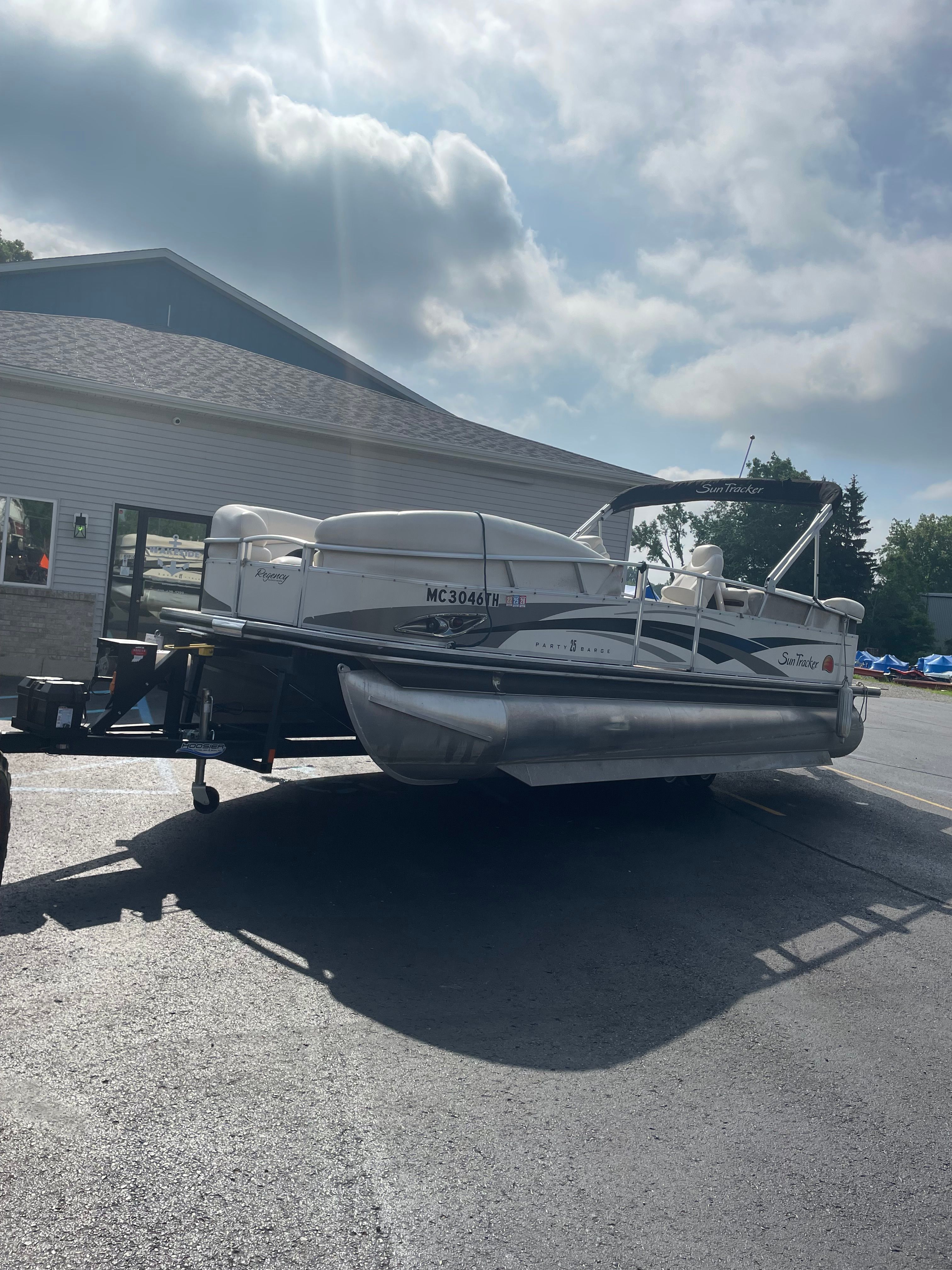 A 2008 Sun Tracker Party Barge 25 Regency Edition on a trailer.