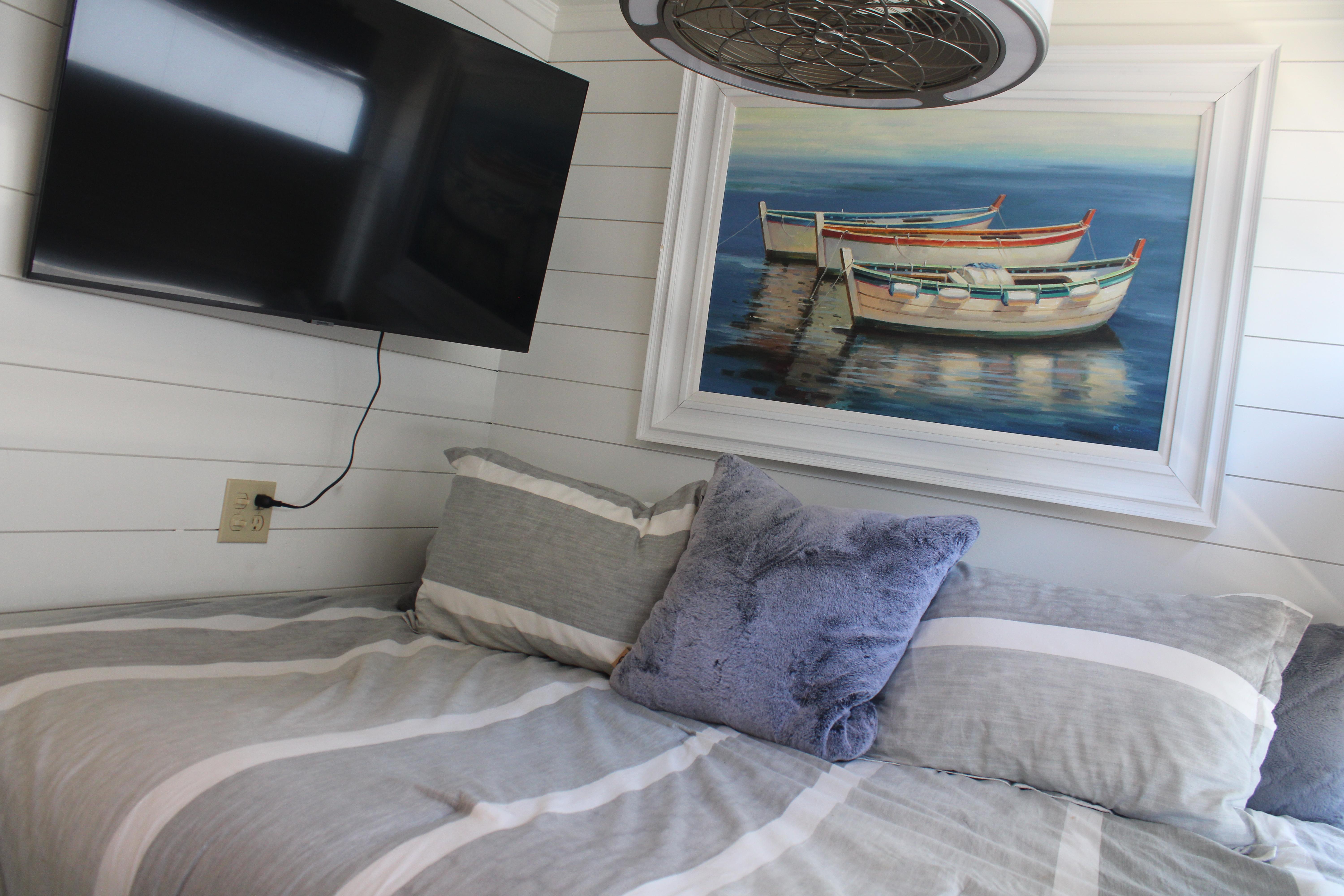 Cozy Sumerset 66 interior with TV, boat painting, and striped bedding, 1992 model.