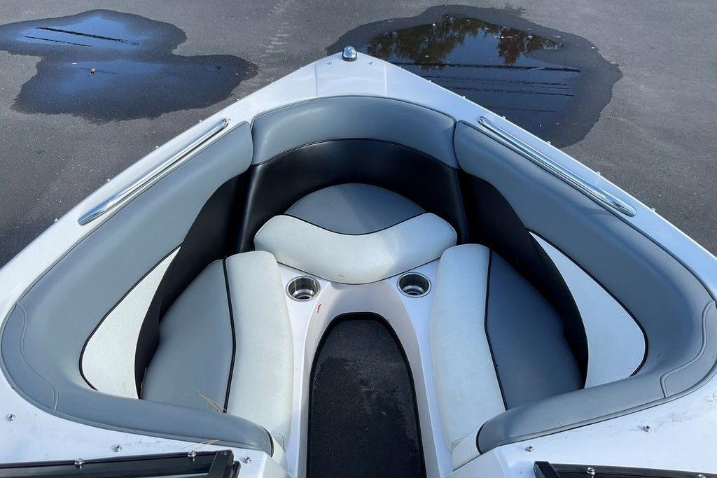 2015 Moomba Outback V boat interior with gray seating and cup holders.