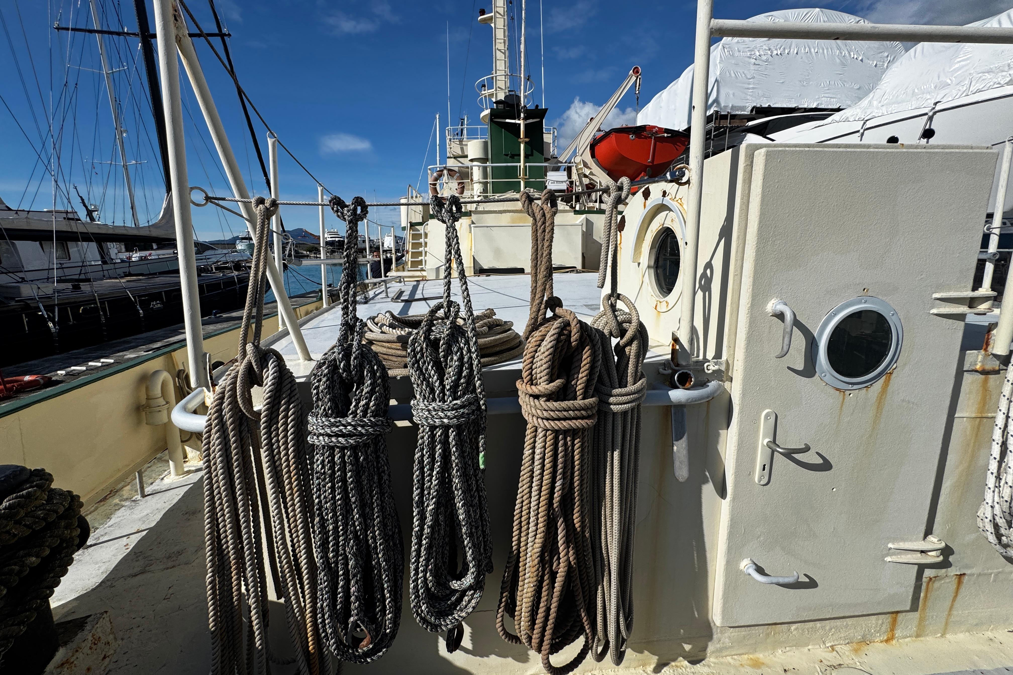 1957 Hitzler Rompighiaccio ship deck with ropes and porthole under clear sky.