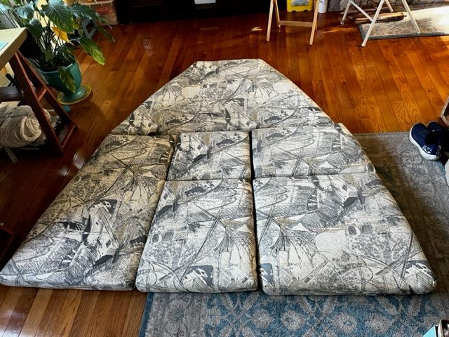 Cushions for a Sport-Craft 252 Sport Fish boat cabin, laid out on a wooden floor.