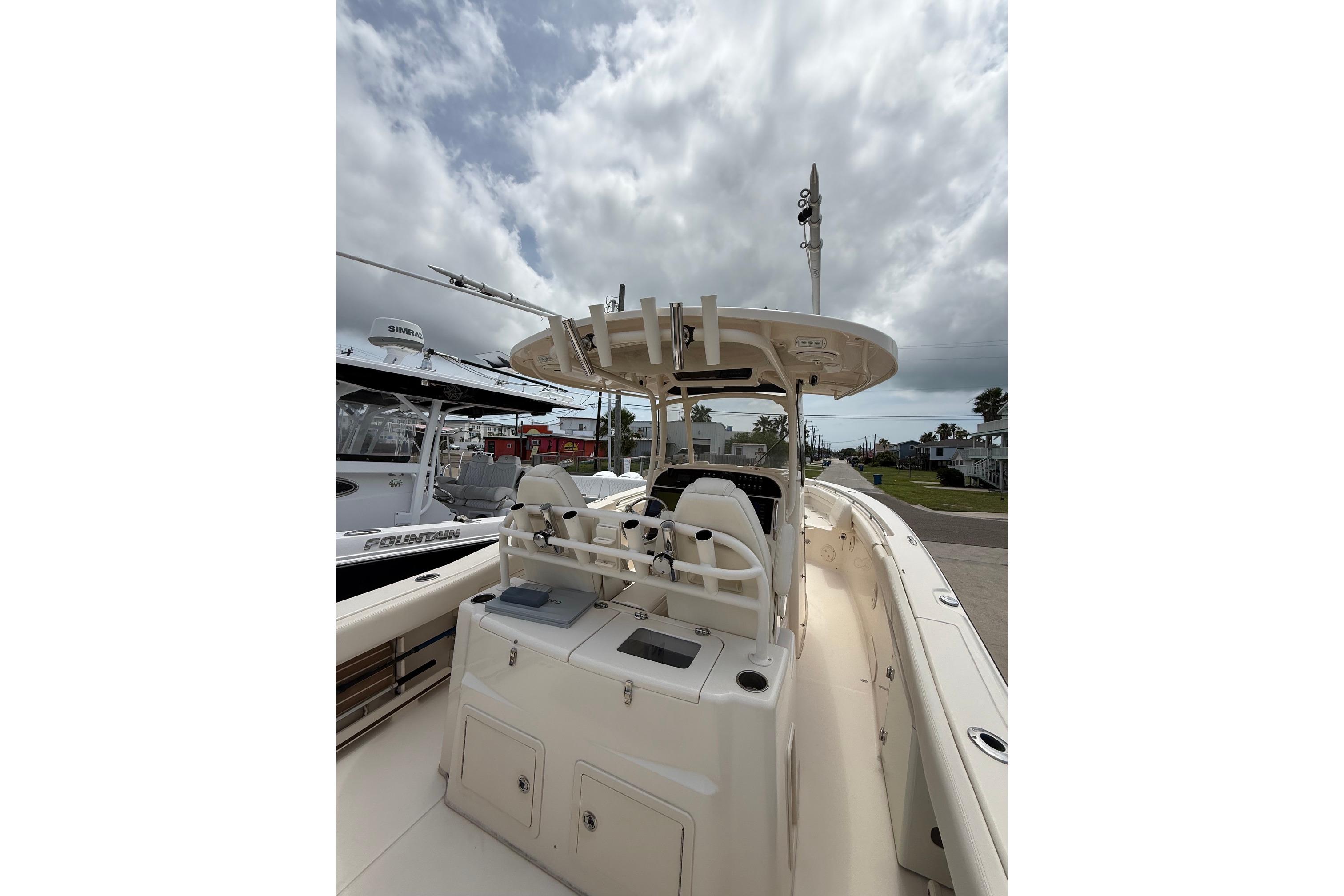 2018 Grady-White Canyon 306 boat with center console and seating, under cloudy sky.