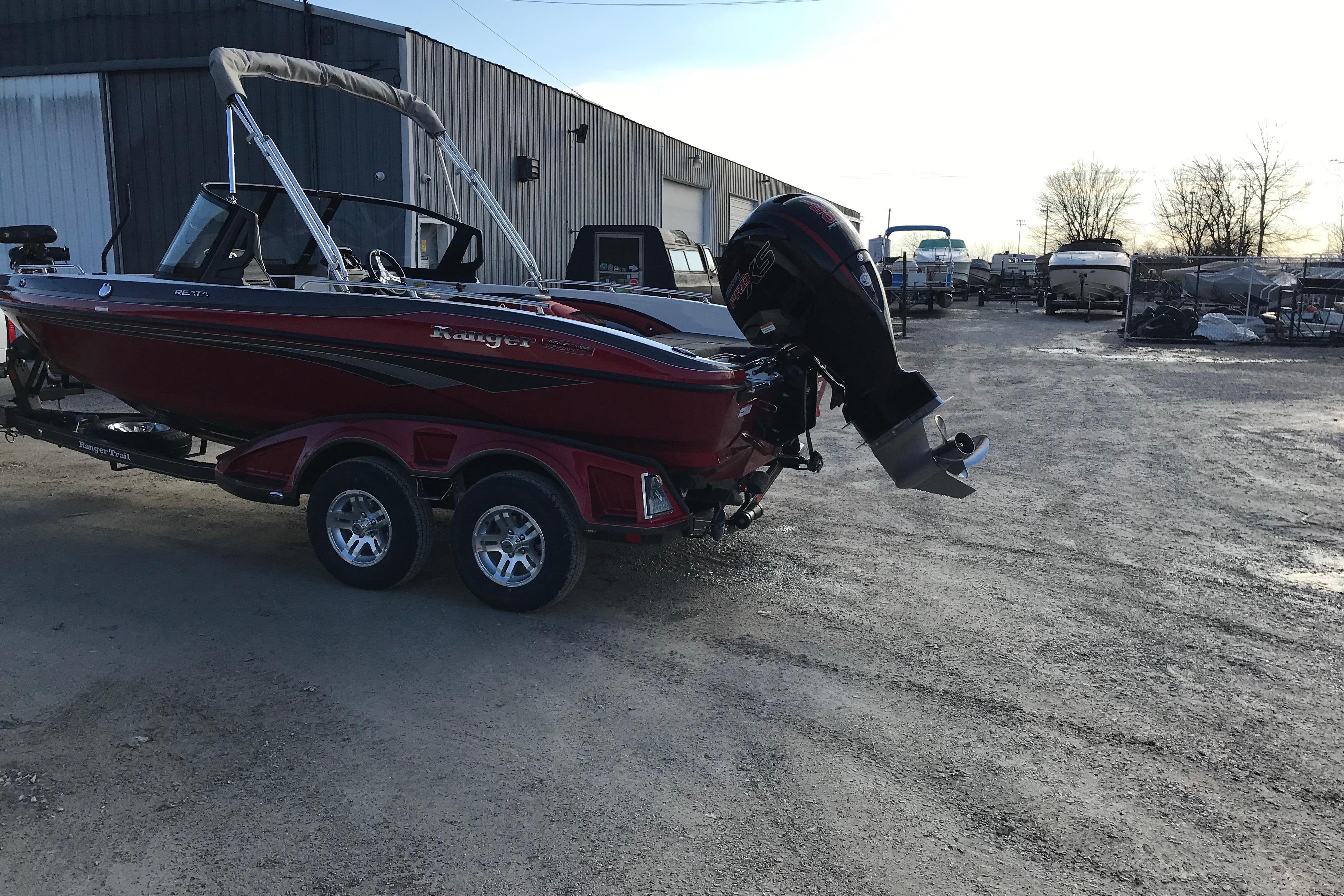 2026 Ranger 1850MS boat on trailer, parked outdoors near a warehouse.