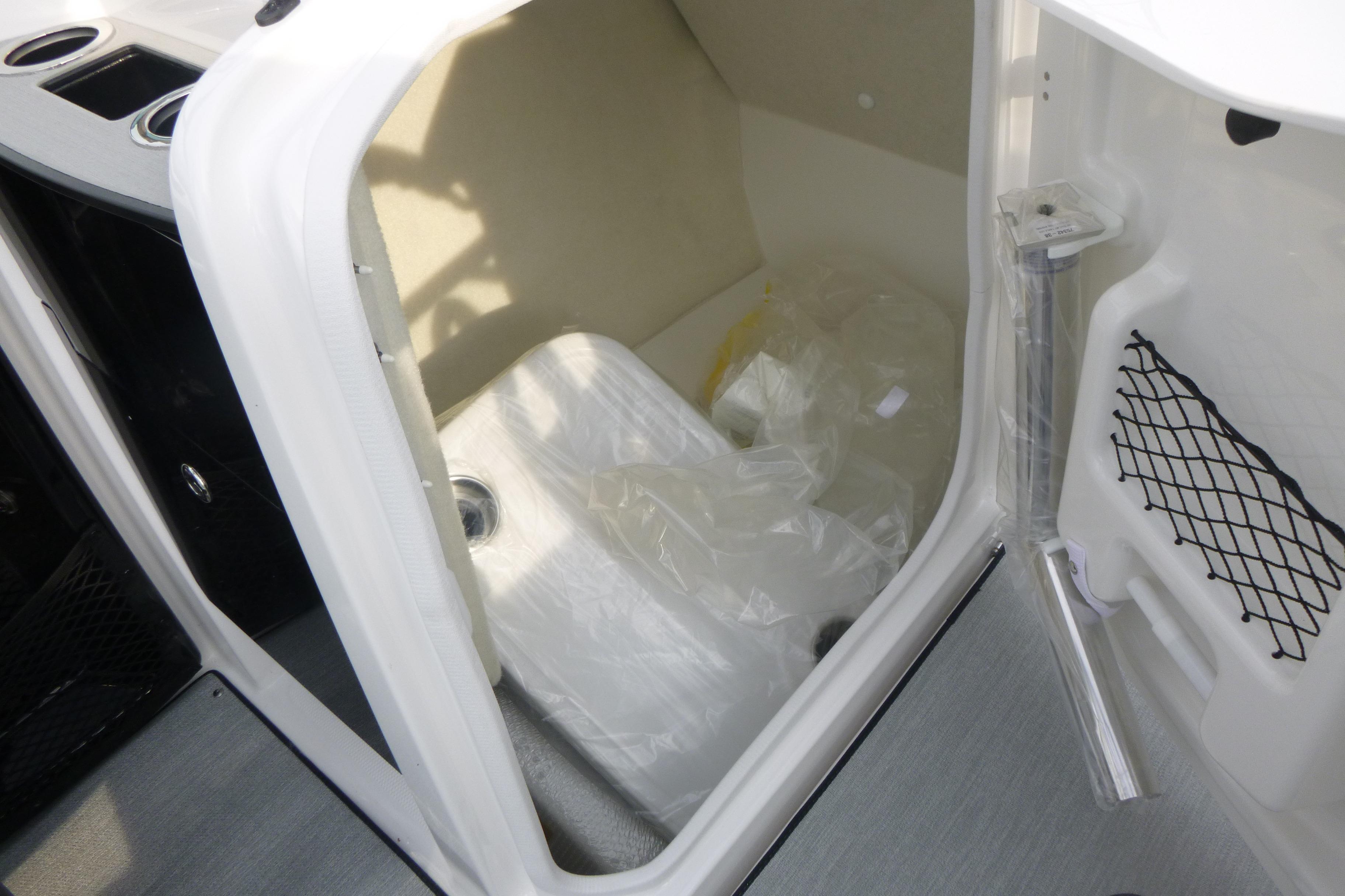 2026 Yamaha Boats AR250 interior storage compartment with netted pocket and cup holders.