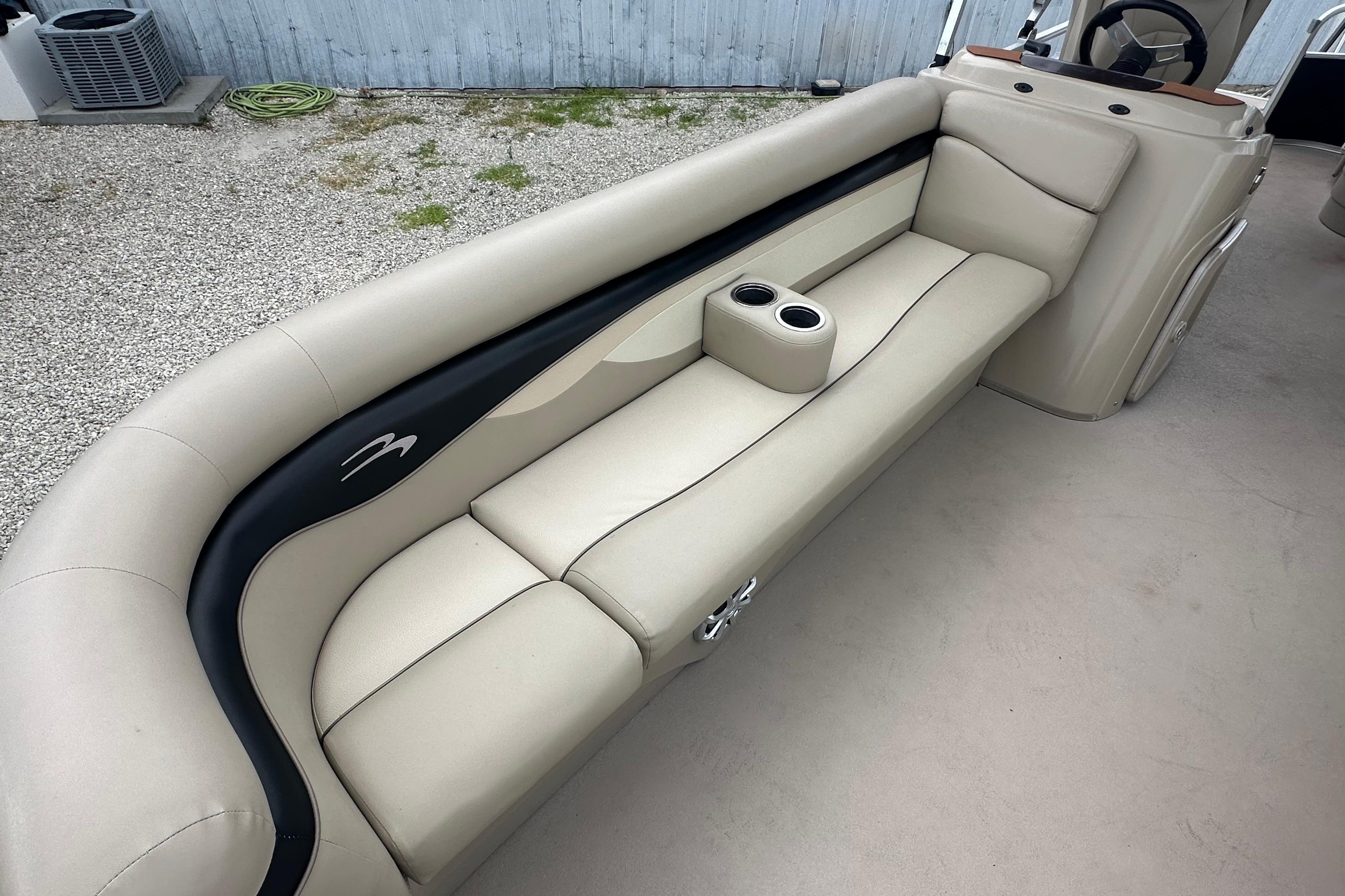 2014 Bennington S22 boat interior with beige seating and cup holders.
