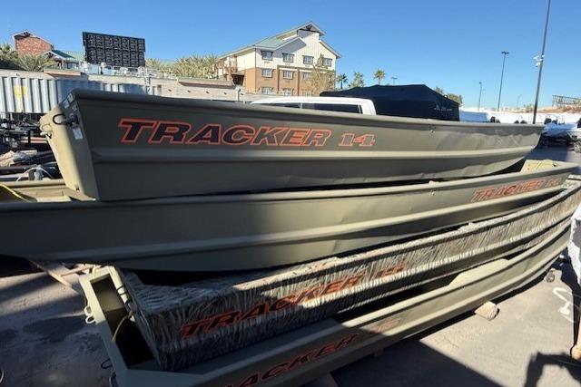 2026 Tracker Grizzly 14 Jon boats stacked outdoors, showcasing durable design and branding.