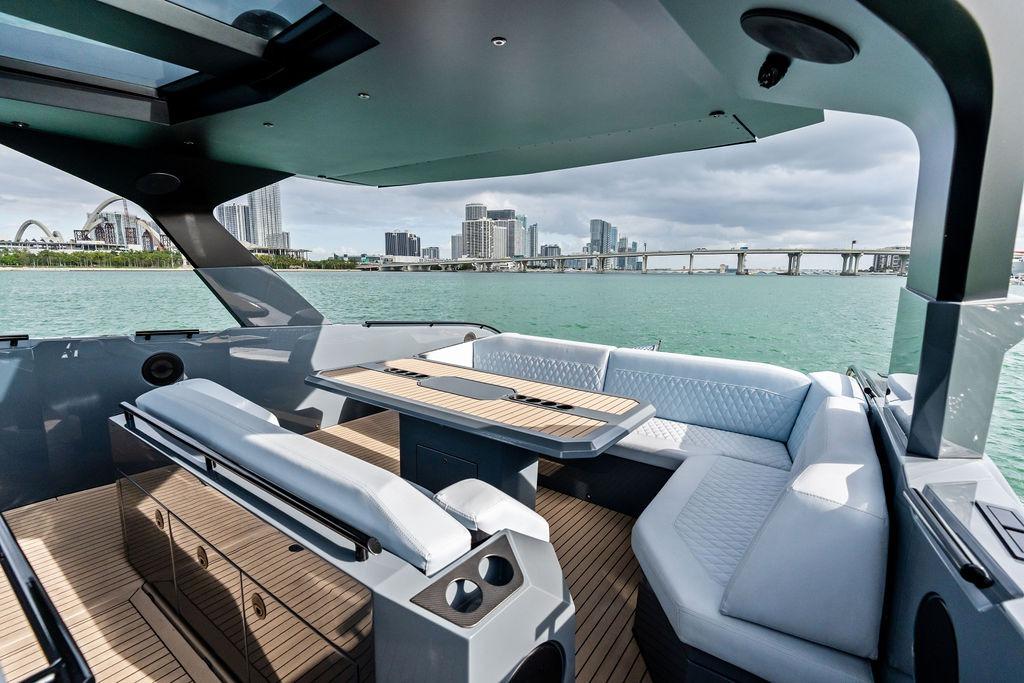 Luxurious 2024 Vanquish Yachts VQ55 interior with elegant seating and scenic waterfront view.