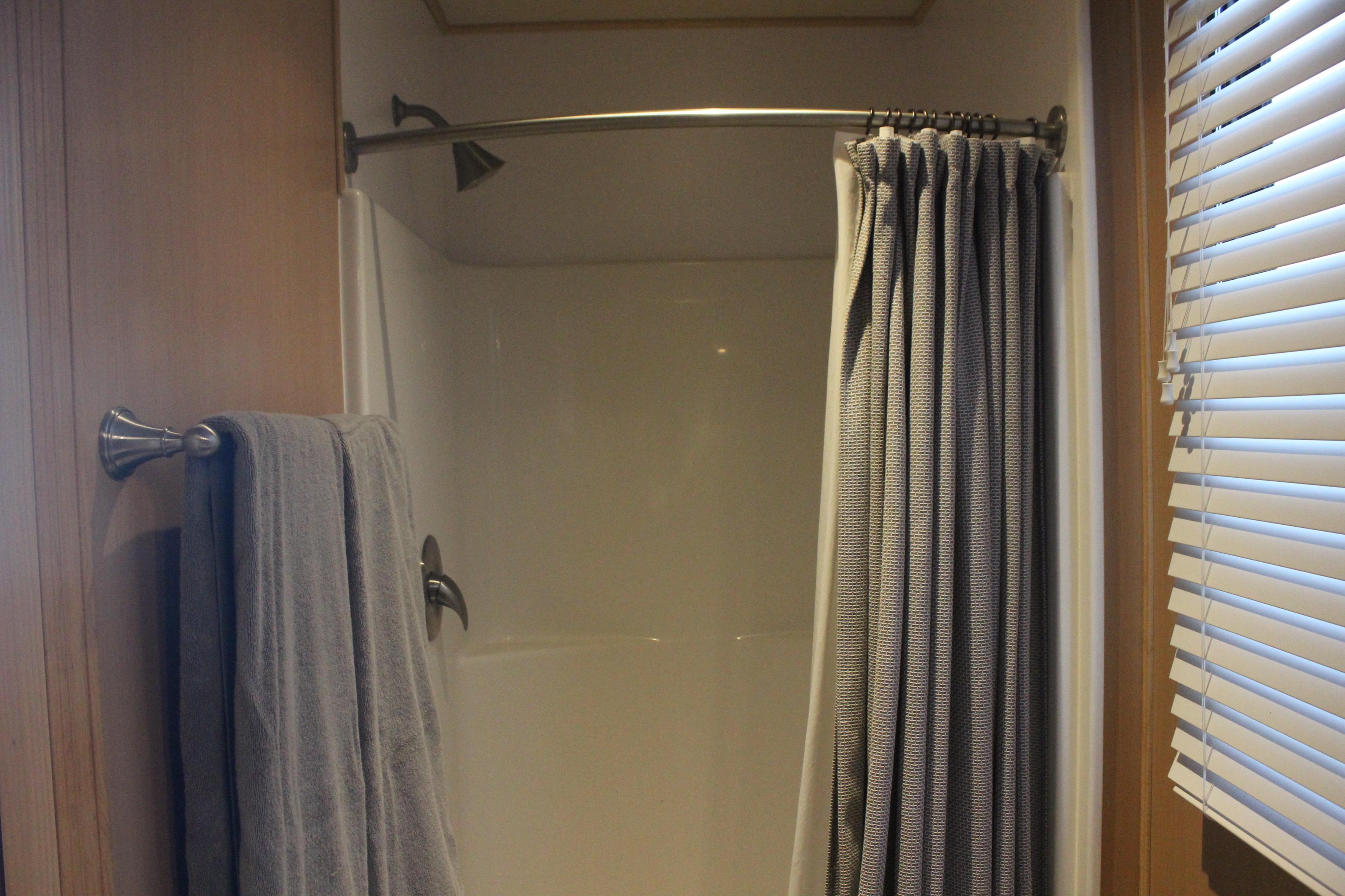 Shower area in 2010 Skipperliner 480 Flybridge with curtain and towel.