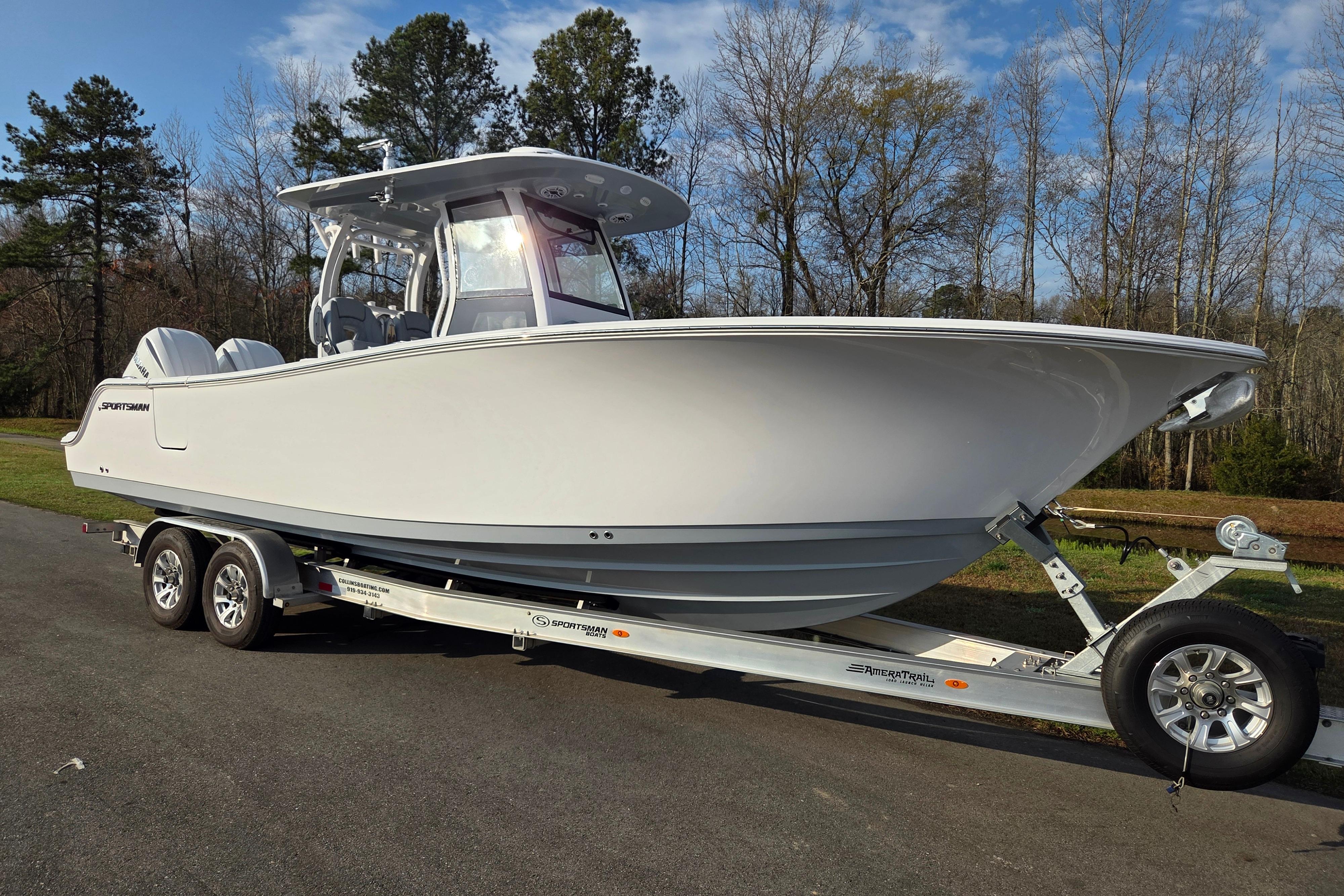 2026 Sportsman Open 282 Center Console boat on trailer, parked outdoors.