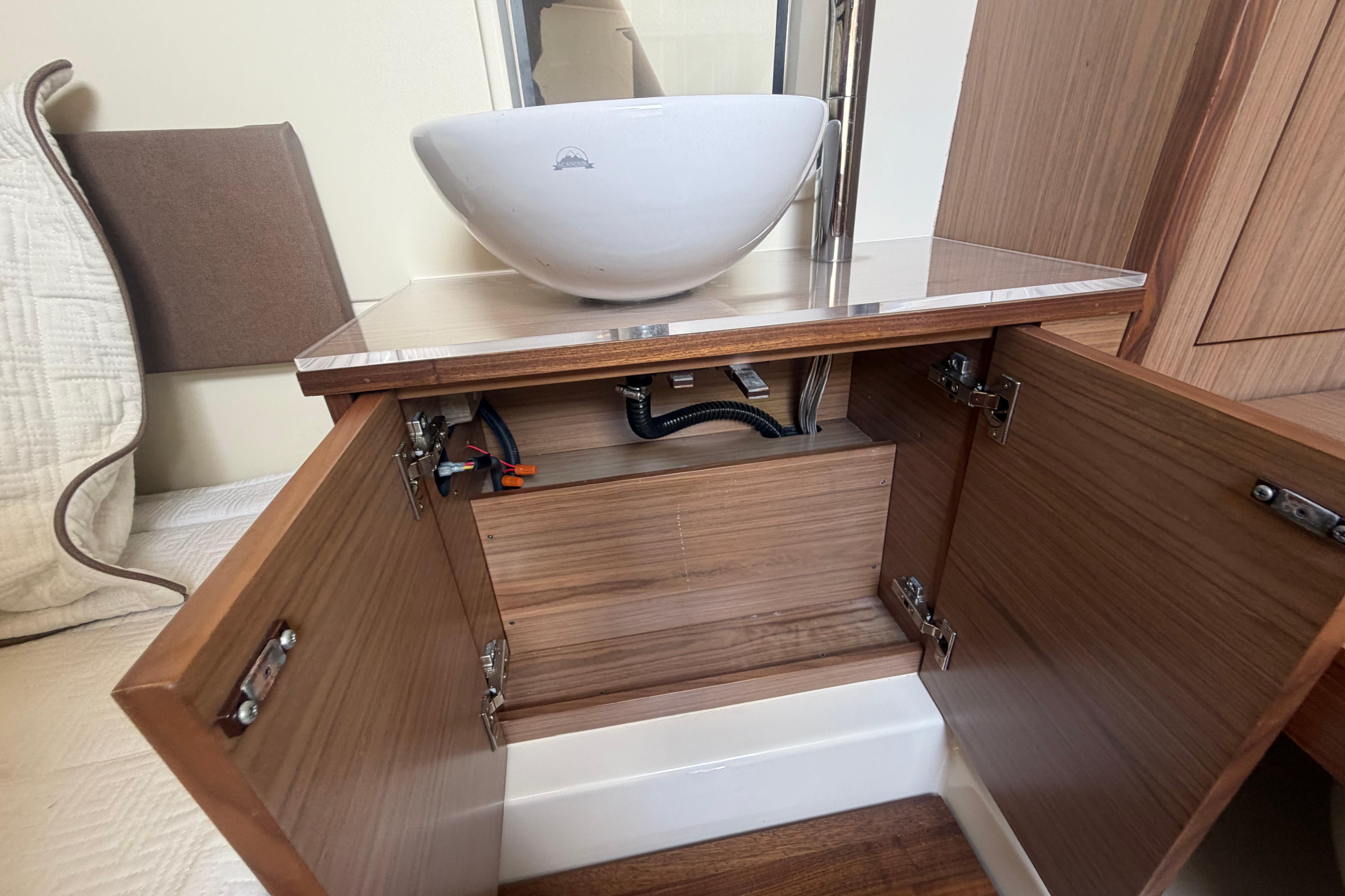 2017 Chris-Craft Catalina 34 interior with open wooden cabinet and modern sink.