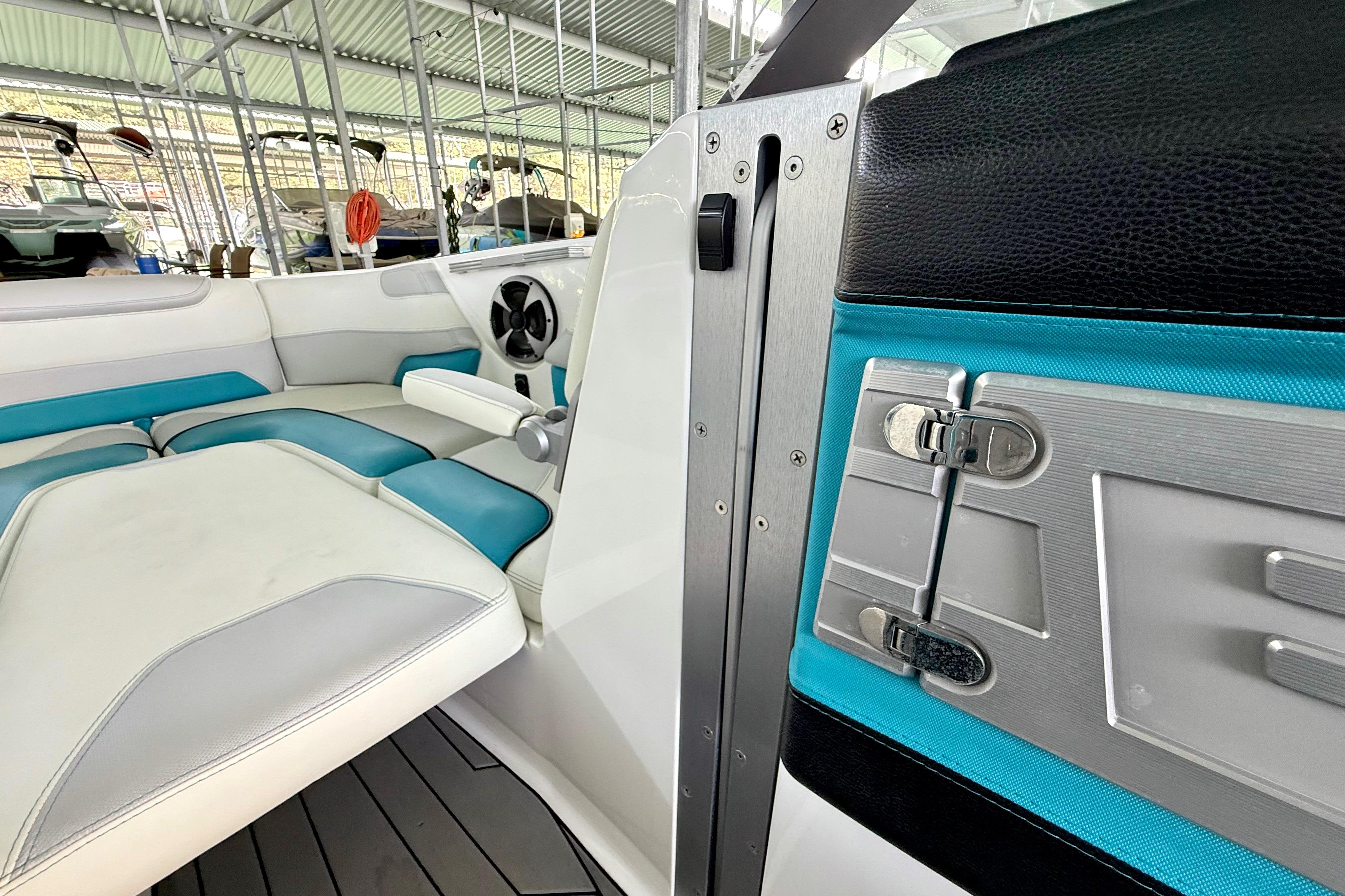 Interior of a 2017 Malibu M235 boat with teal and white seating.