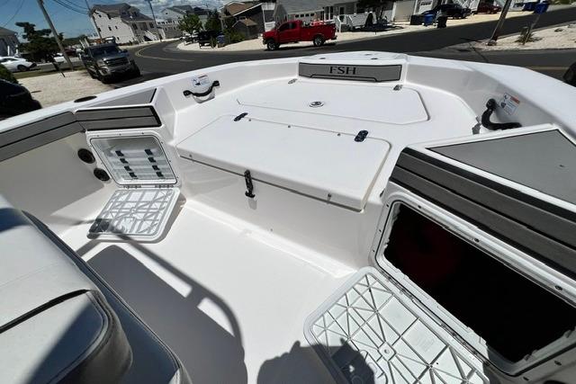 2019 Yamaha Boats 190 FSH Sport interior with storage compartments and seating.