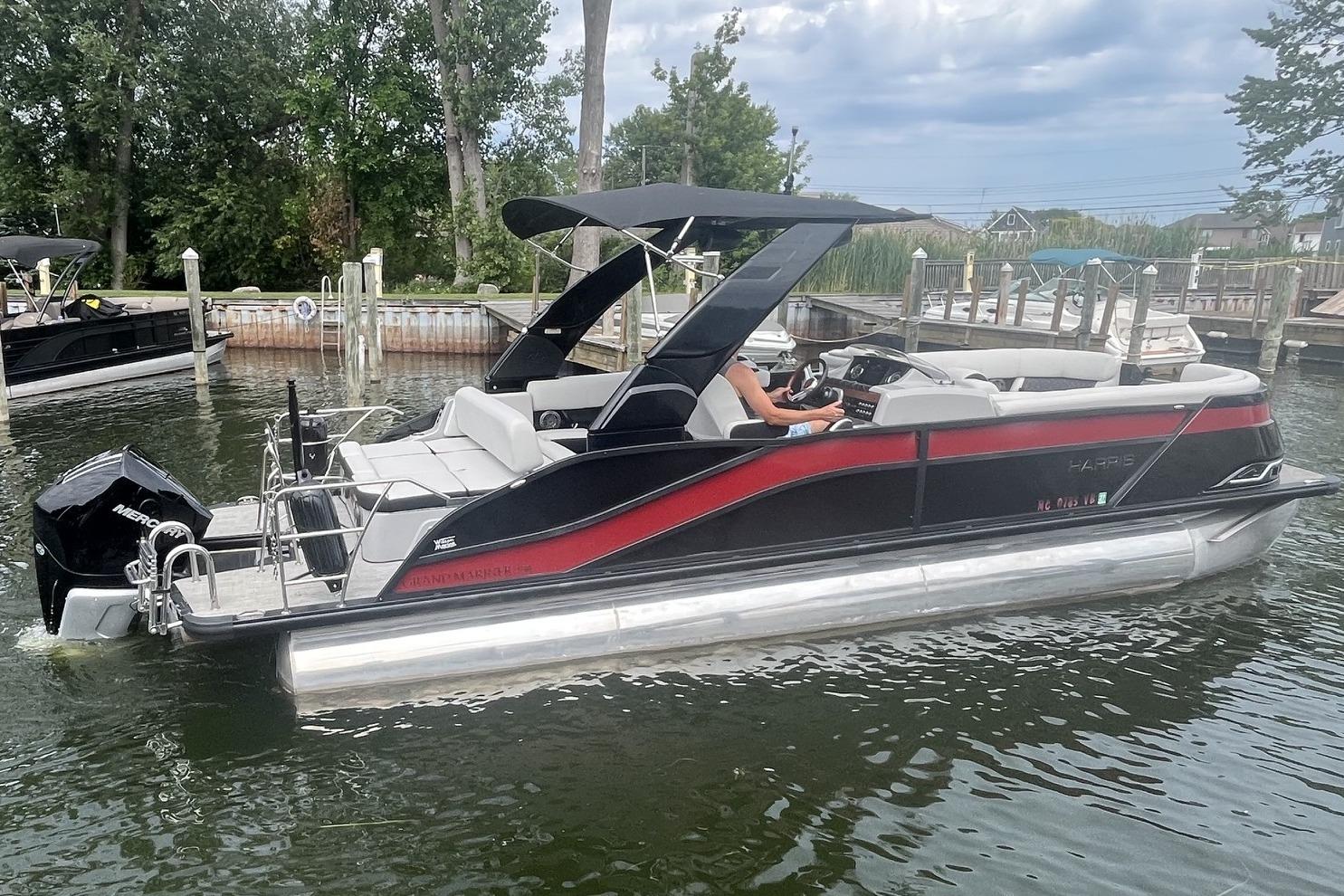 2024 Harris Grand Mariner 250 pontoon boat on water, featuring sleek design and modern amenities.
