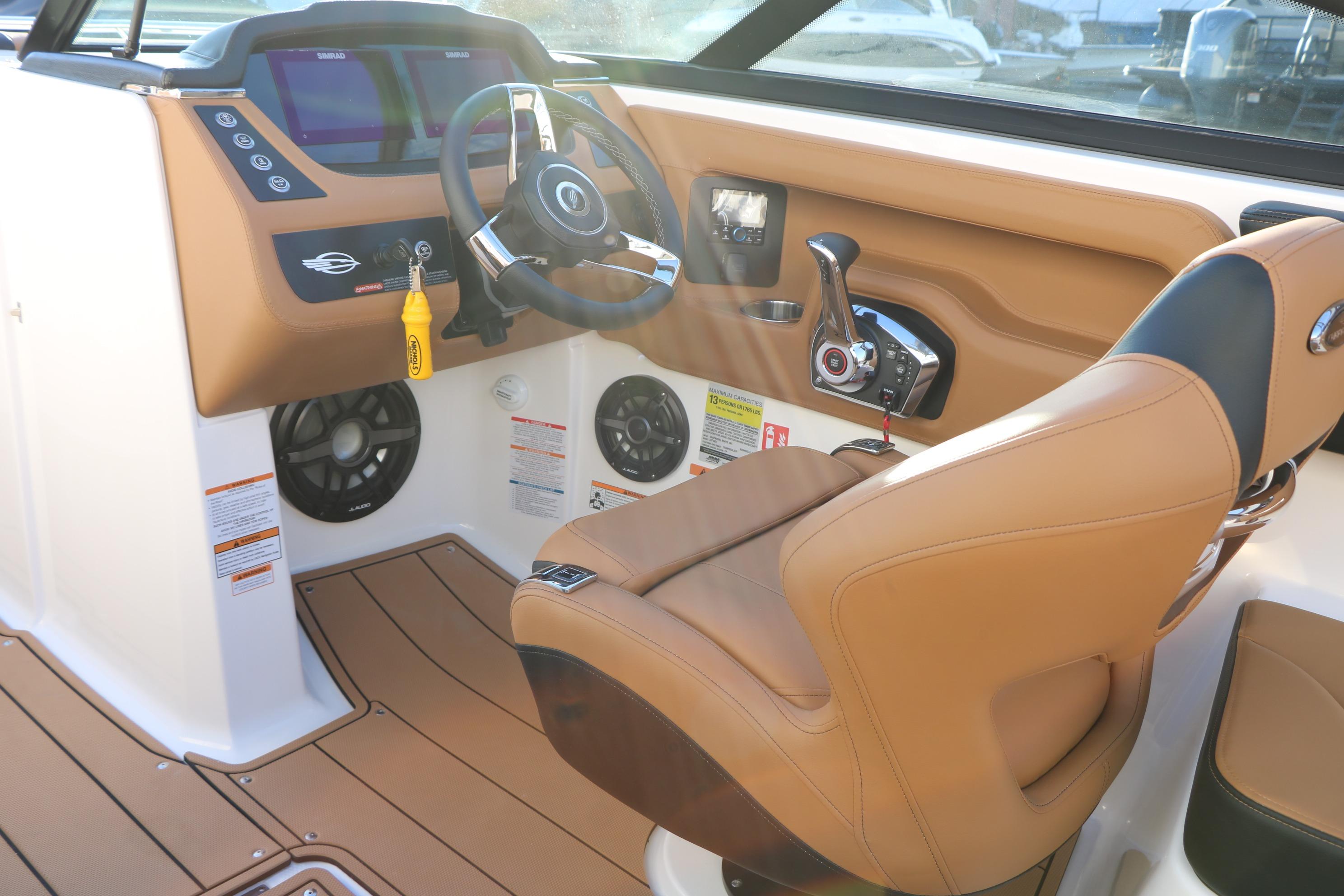 2026 Chaparral 247 SSX boat cockpit with tan leather seating and modern controls.