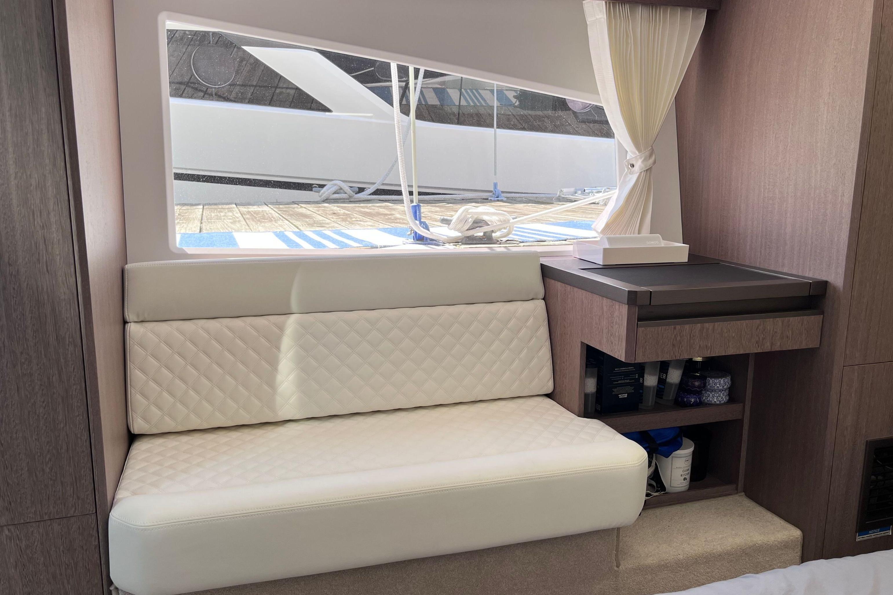 Interior of 2024 Galeon 425 HTS yacht with white seating and wooden accents.