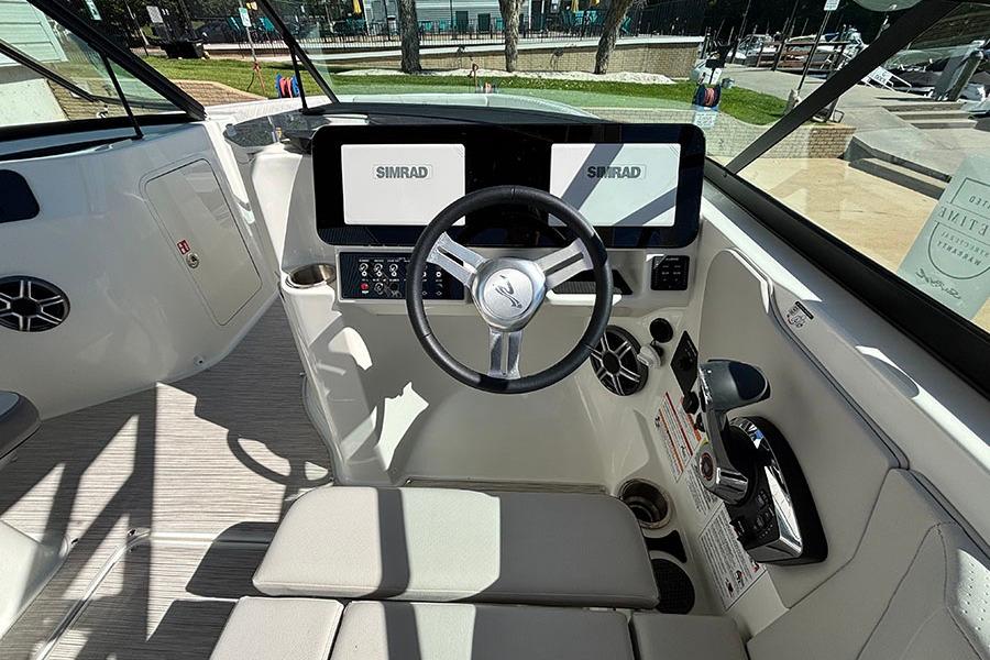 2027 Sea Ray SDX 230 Outboard helm with Simrad displays and modern steering wheel.