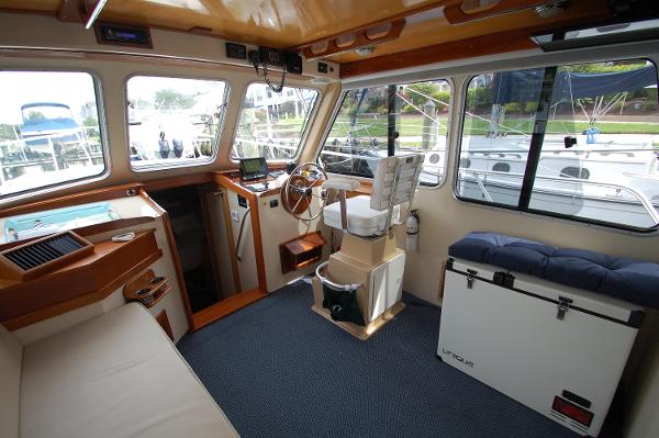 Interior of a 2005 Fox Island Thirty - Sedan Cruiser with helm and seating area.