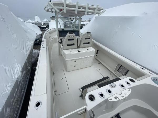 2023 Sailfish 290 CC boat interior with dual seats and console, docked and covered.