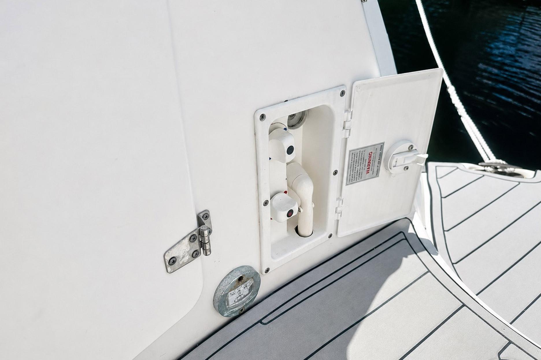2012 Rinker 310 Express Cruiser LE water hookup compartment on deck.