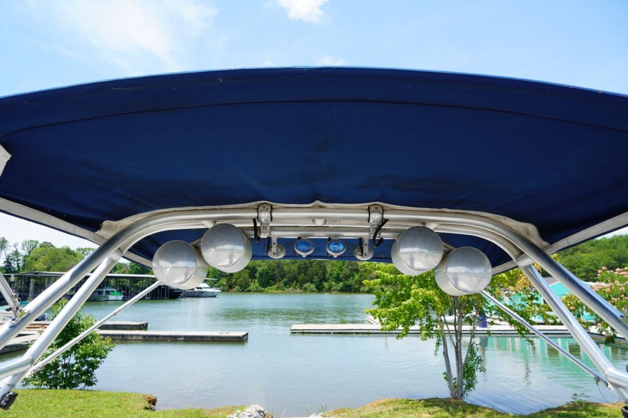 2004 Crownline 216 LS boat canopy with lake view in background.