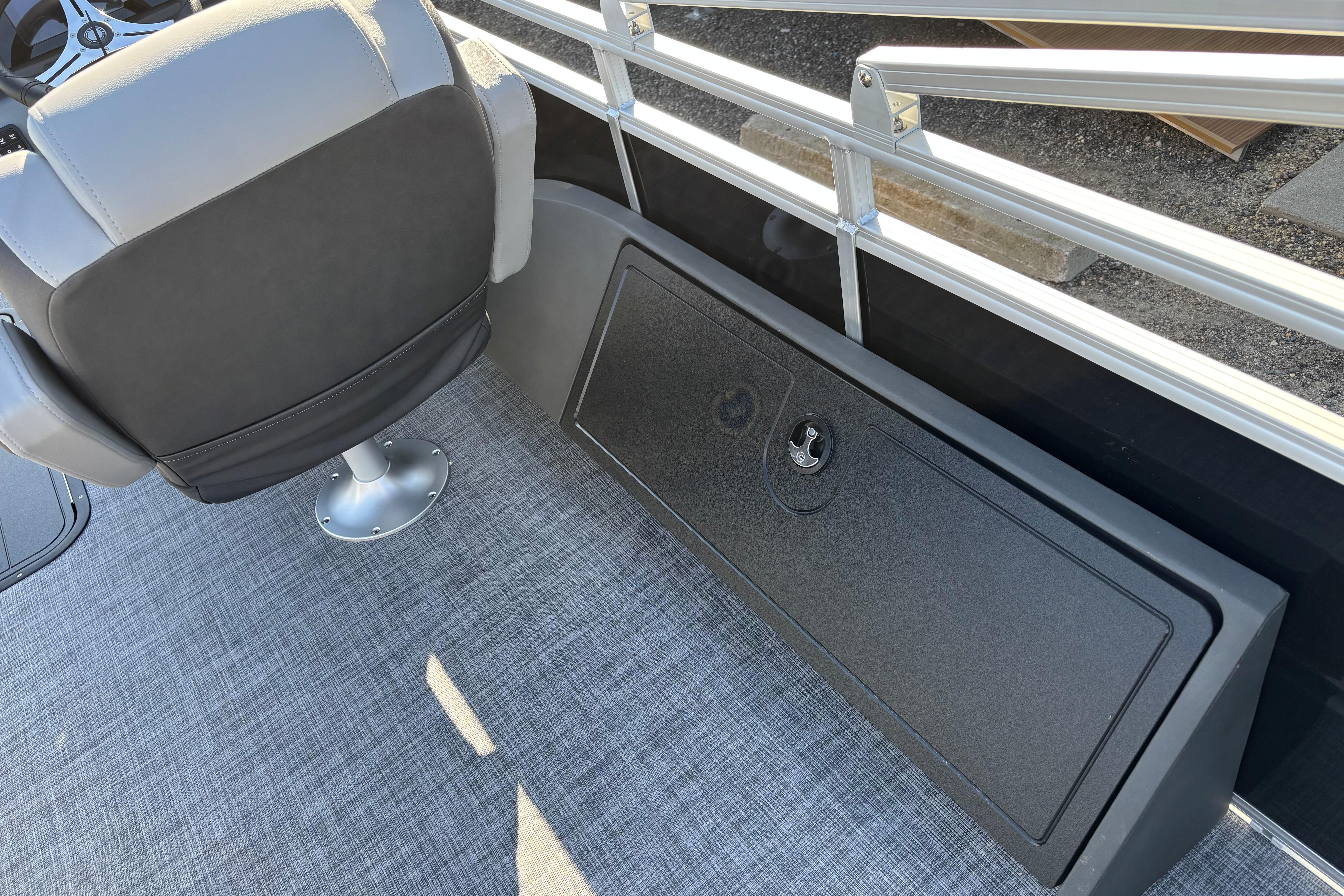 2026 Sun Tracker SportFish 22 XP3 boat interior with gray seating and storage compartment.