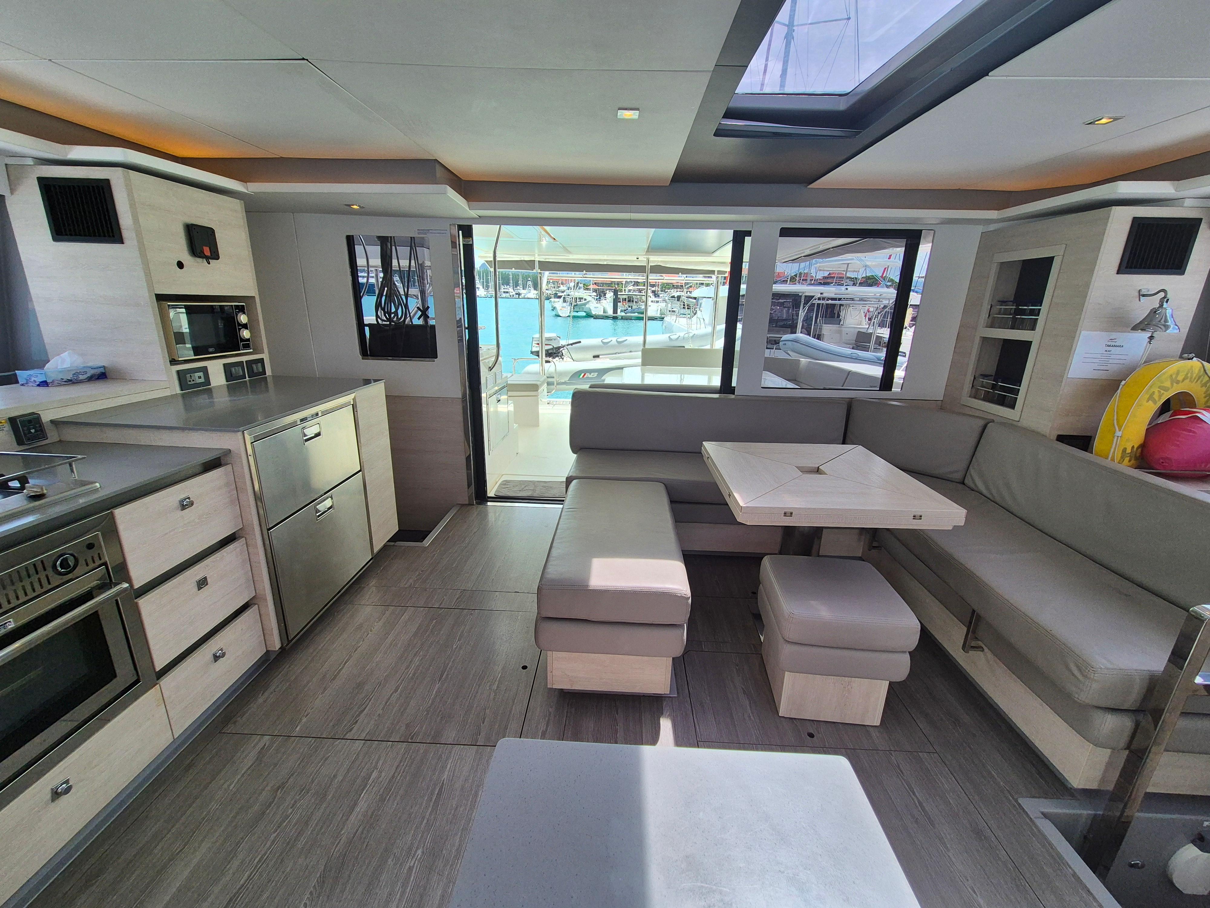 Luxurious interior of a 2020 Leopard 50 yacht with modern kitchen and seating area.