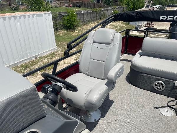 2023 Regency 250 DL3 boat interior with gray captain's chair and steering wheel.