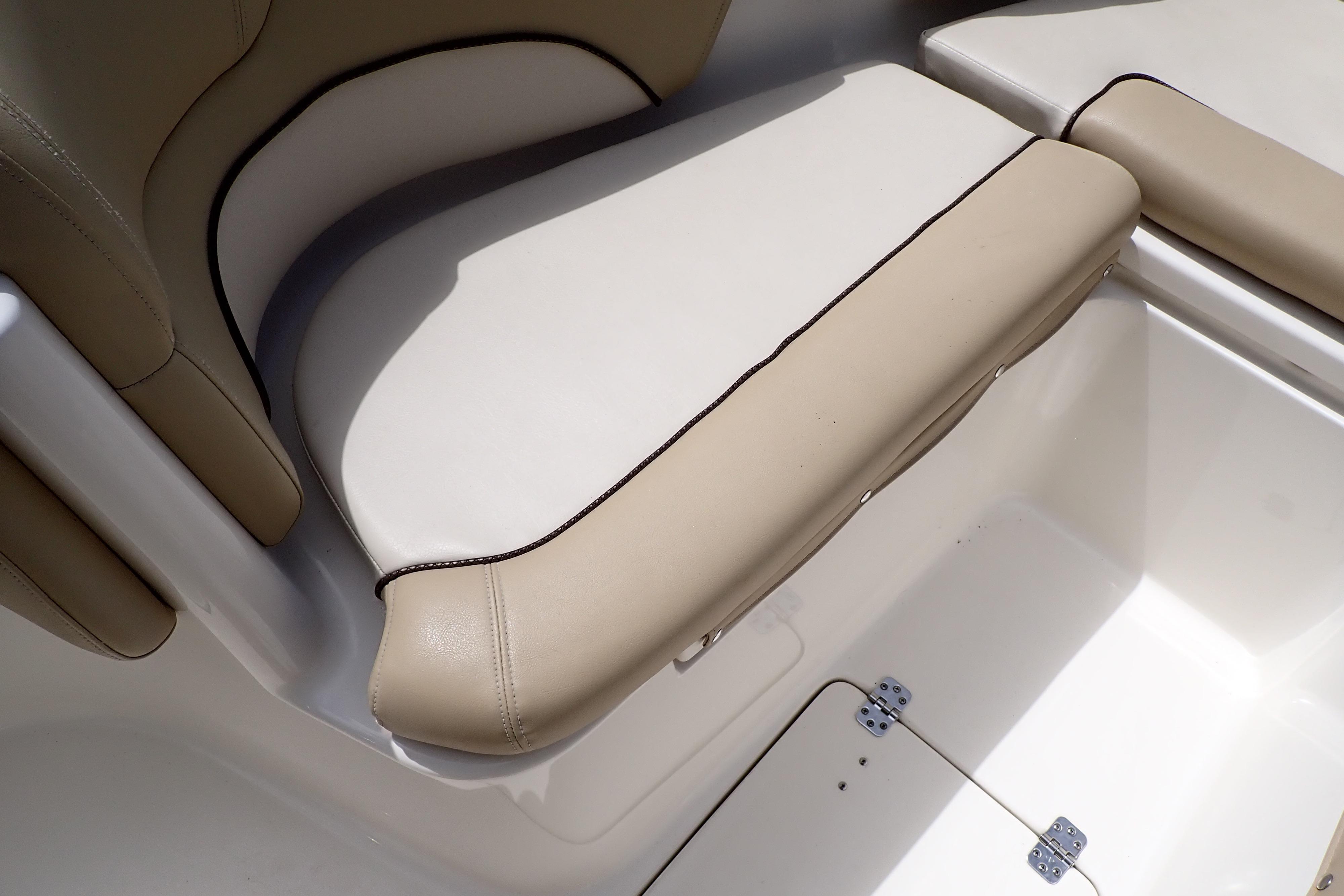 2019 Key West 263 FS boat seat with beige upholstery and storage compartment.