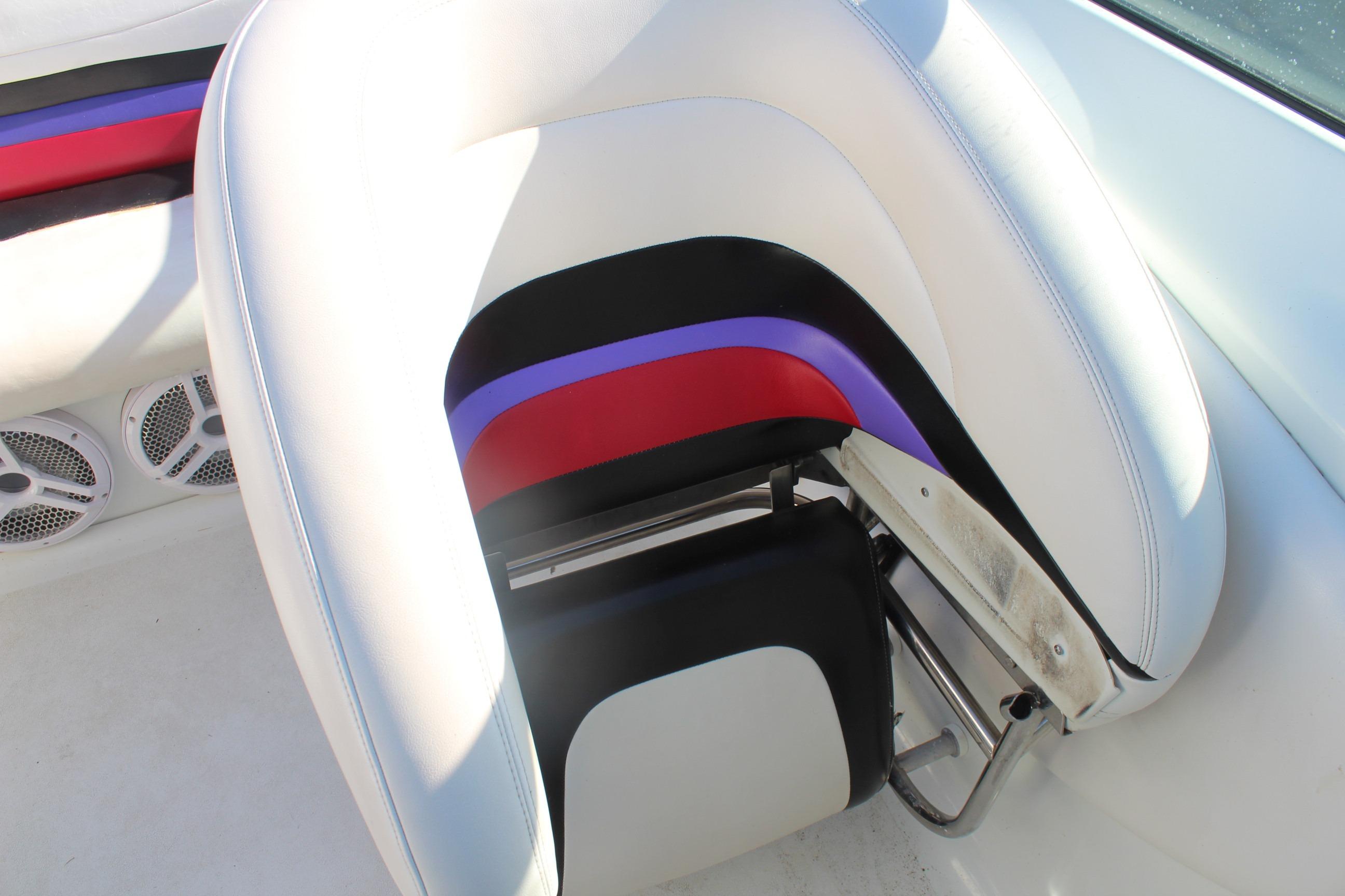 1996 Baja 232 boat interior with colorful seat design and speaker system.