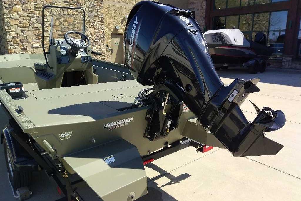 2026 Tracker Grizzly 1860 CC boat with Mercury outboard motor, parked outdoors.