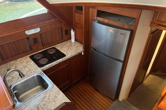 1991 Post 50 Convertible yacht kitchen with granite countertops and stainless steel appliances.