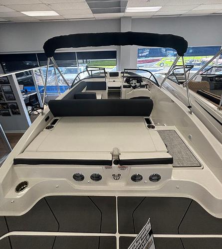 2024 Bayliner DX 2050 boat interior with seating and canopy.