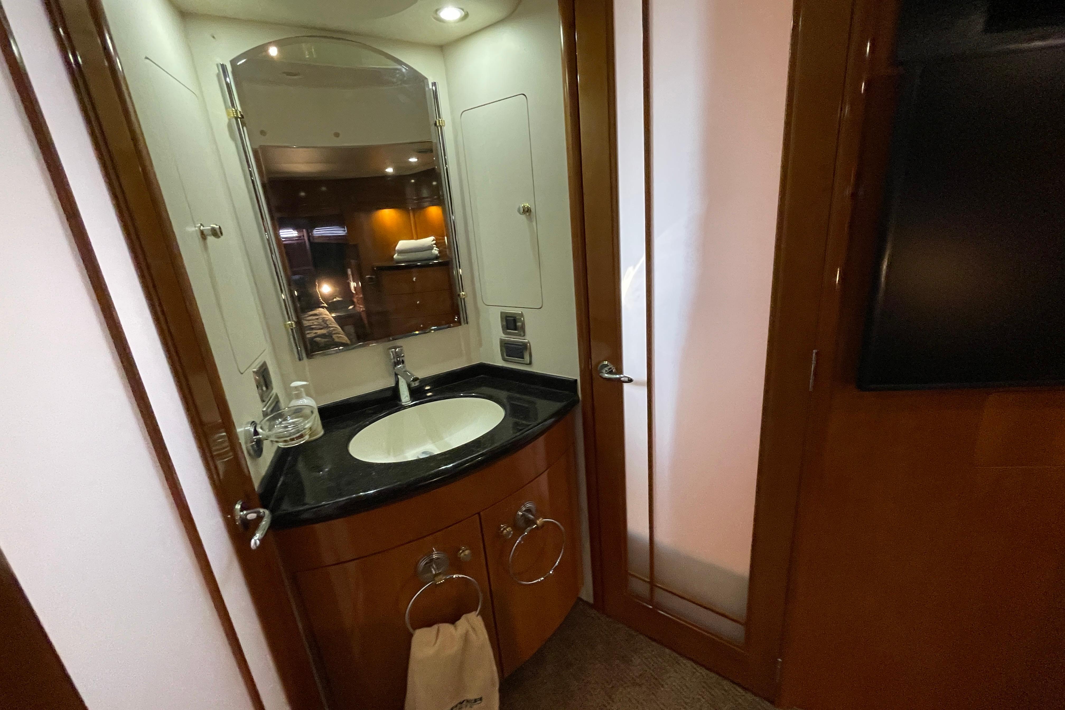 Luxurious bathroom in 2002 Carver 570 Voyager Pilothouse yacht with elegant wood finish.