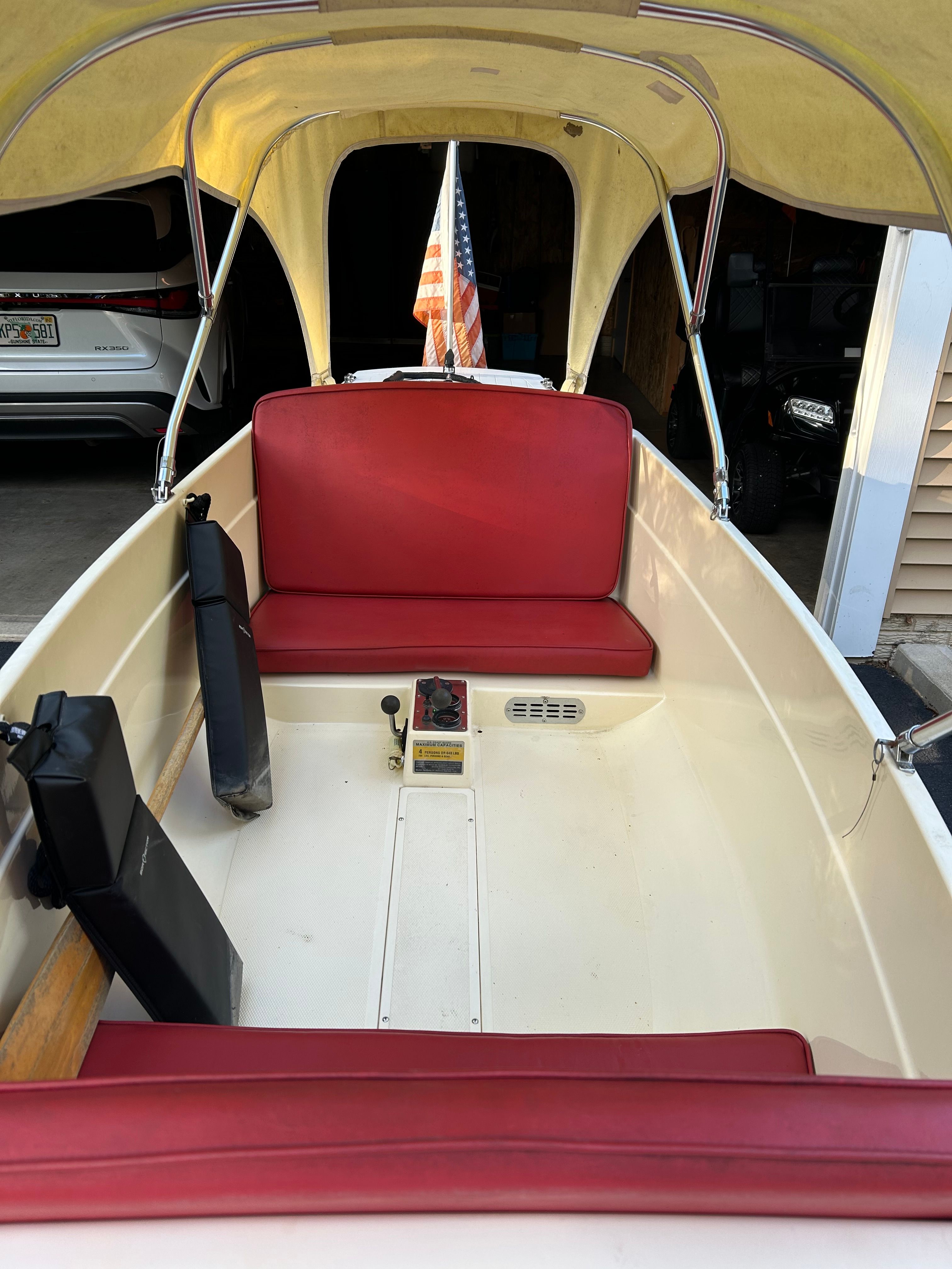 1995 Elco Launchboat with red seats and canopy.