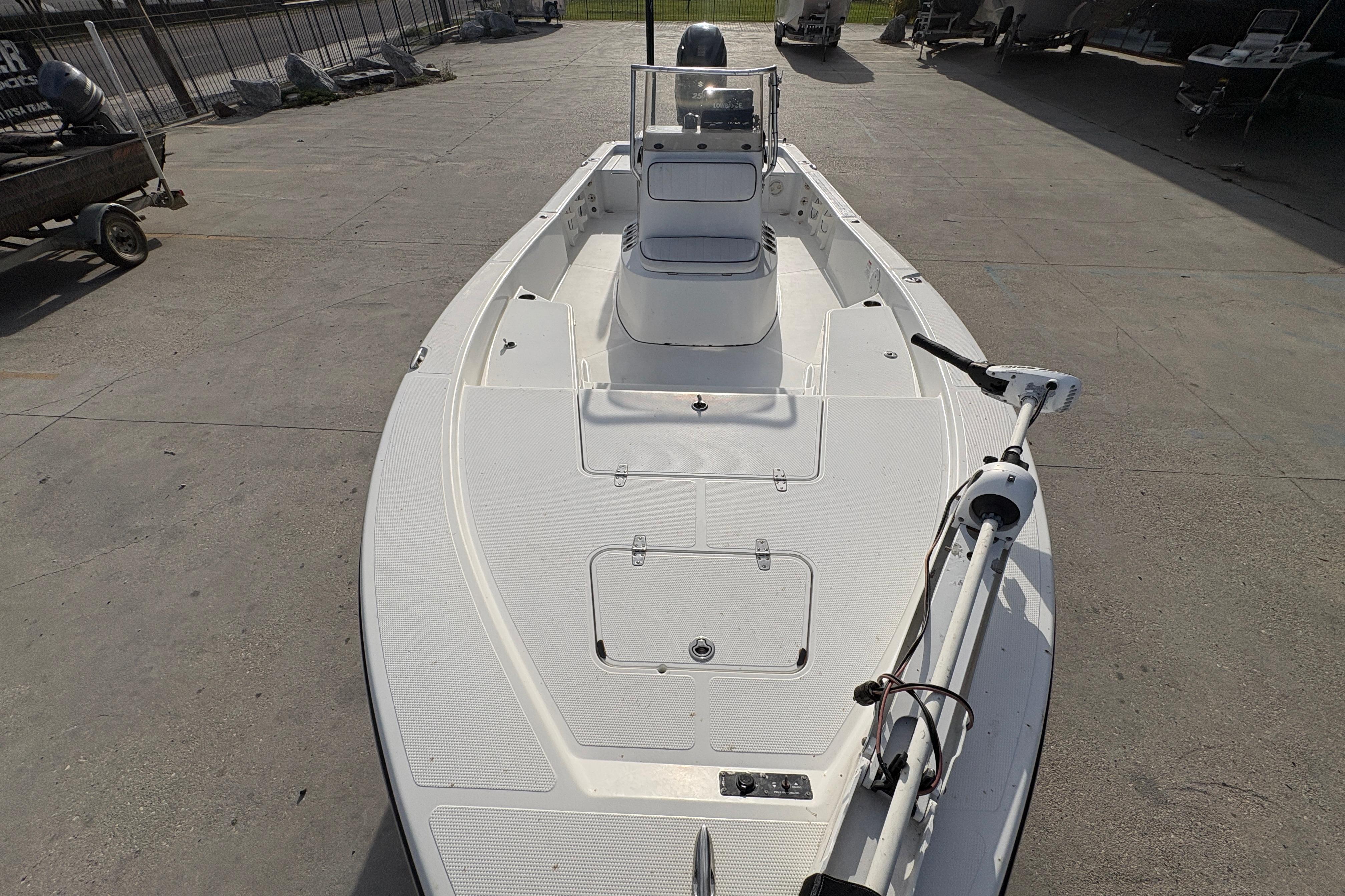 2012 BlackJack 224 boat on concrete surface, featuring a sleek white deck design.
