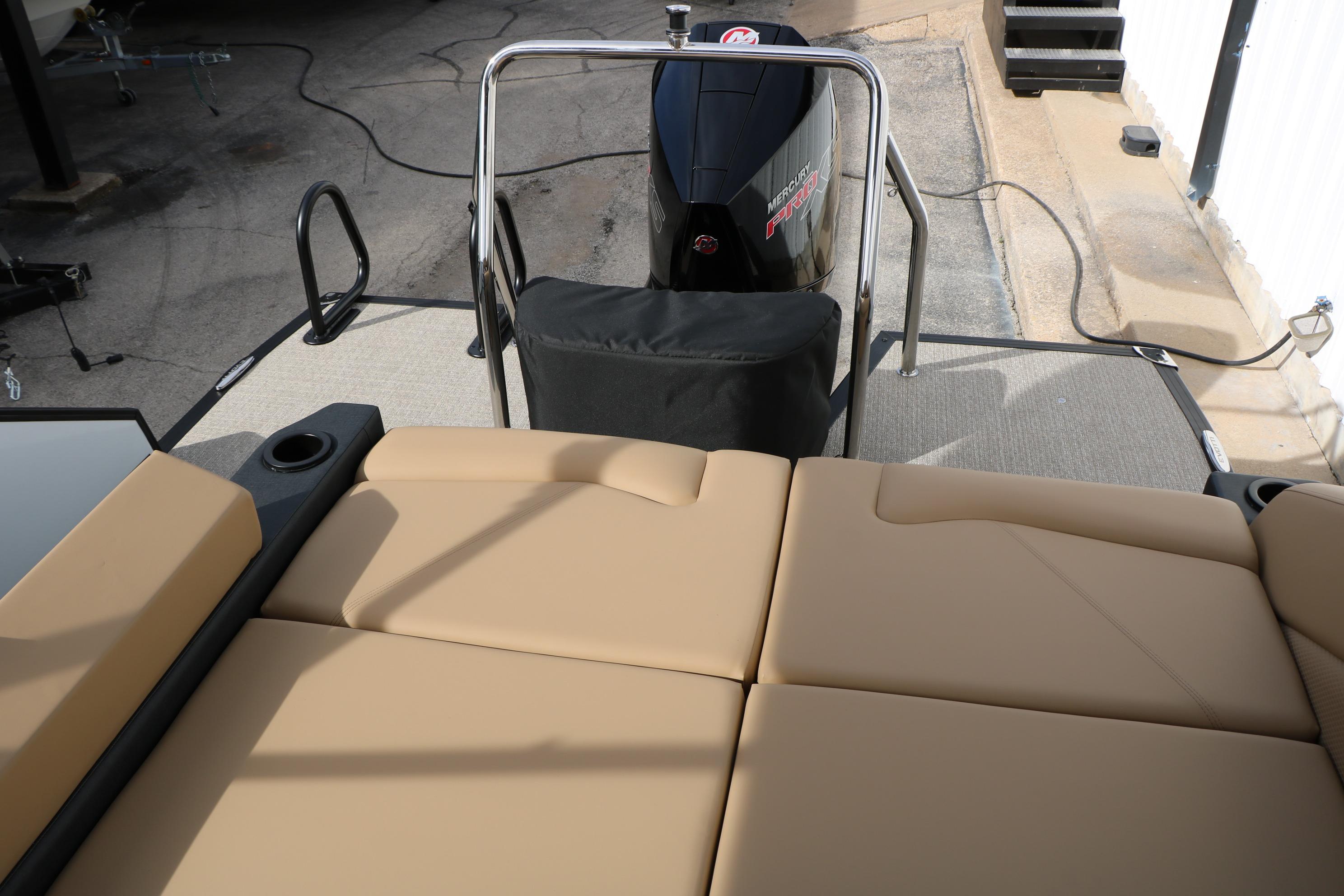2026 Evotti 523CS boat with tan seating and Mercury engine, docked outdoors.